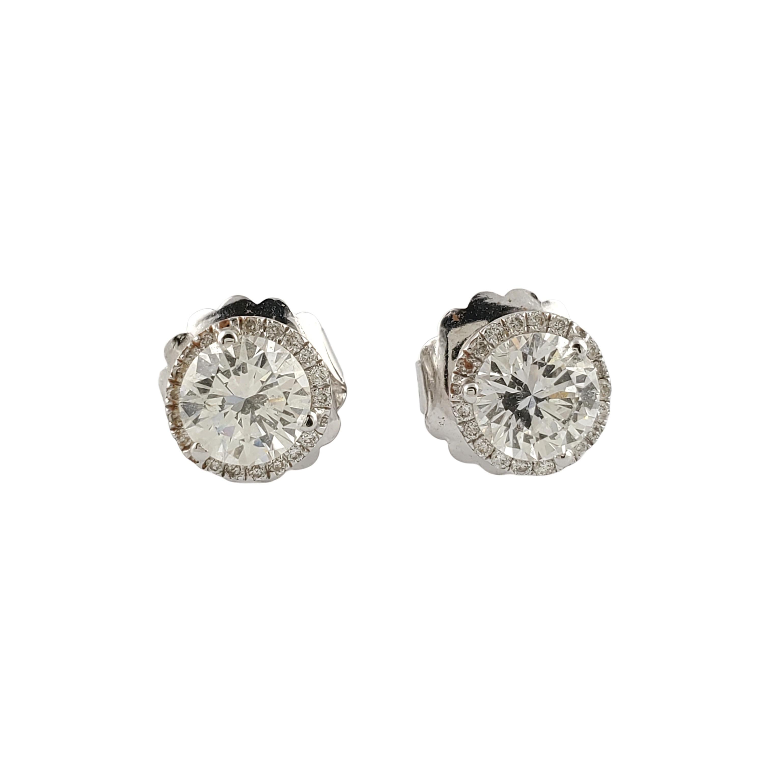 GAI Certified 14K White Gold Diamond Halo Stud Earrings

These gorgeous diamond halo stud earrings are set in 14K white gold

2 round brilliant diamond, approx. .95cts each, are surrounded by a halo of small round brilliant diamonds.
Total diamond