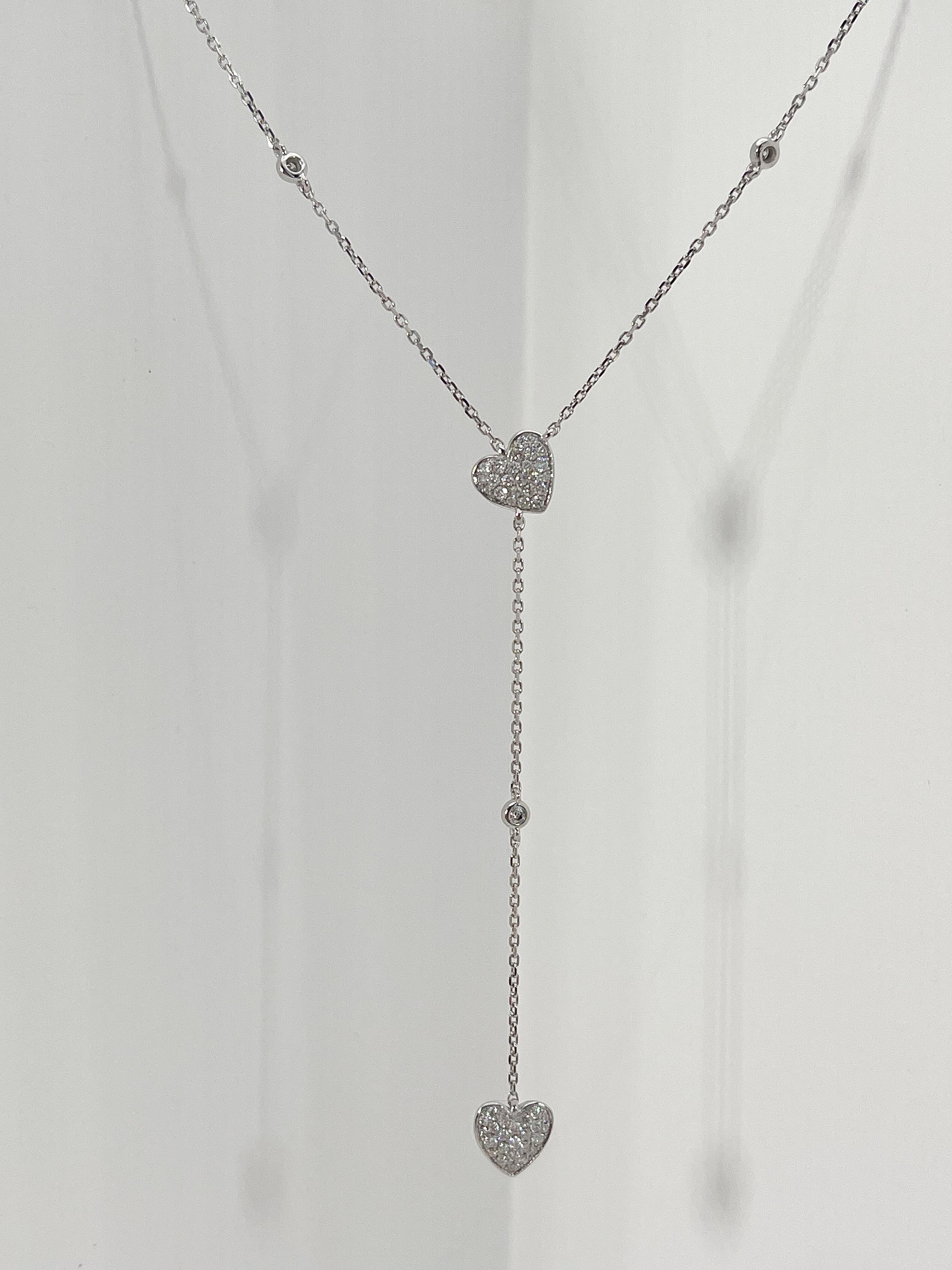 14k white gold drop necklace with round diamonds in the hearts and 3 round diamond stations, diamonds have a total carat weight of .28, the necklace is 16 inches with an extension at 17 and 18, chain is a diamond cut cable, has a lobster claw to