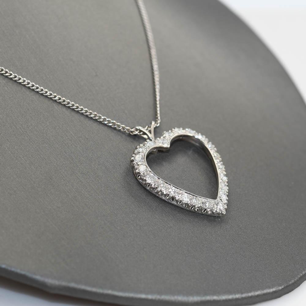 14k white gold necklace with diamond heart pendant.
Stamped 14k and weighs 10.7 grams.
The diamonds are round brilliant cuts, 1.75 total carats, i to j color range, si to i1 clarity.
The pendant measures 1 1/4 inches long by 1 inch wide.
The chain