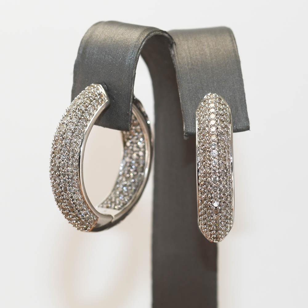 Ladies 14k white gold and diamond hoop earrings.
Stamped 14k, D286 and weighs 15.2 grams.
The diamonds are round brilliant cuts, 2.86 total carats,  i, j, k color range, i1 clarity.
The hoops are 6.8mm thick and measure 1 1/8 inches in