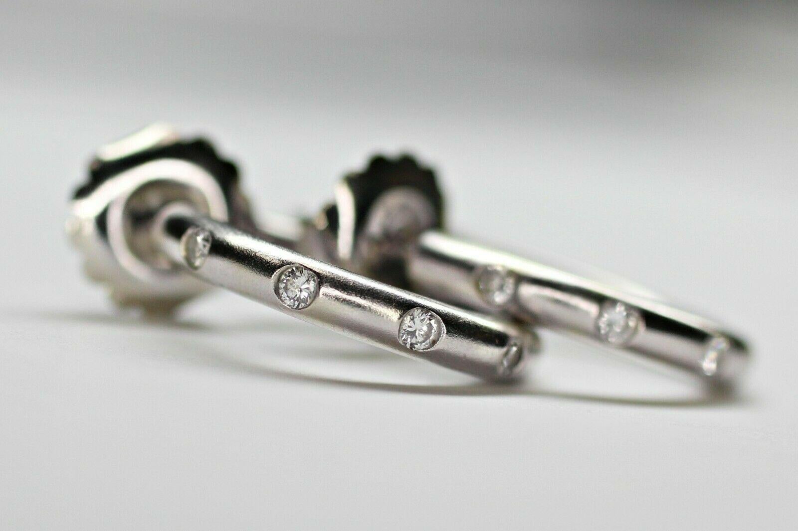 This is a 14k white gold diamond hoop earrings with approximately 0.34 carat total weight of round diamonds embedded symmetrically into the earrings with a sandblast finish. The earrings comes with tight jumbo push backings to keep them secure and