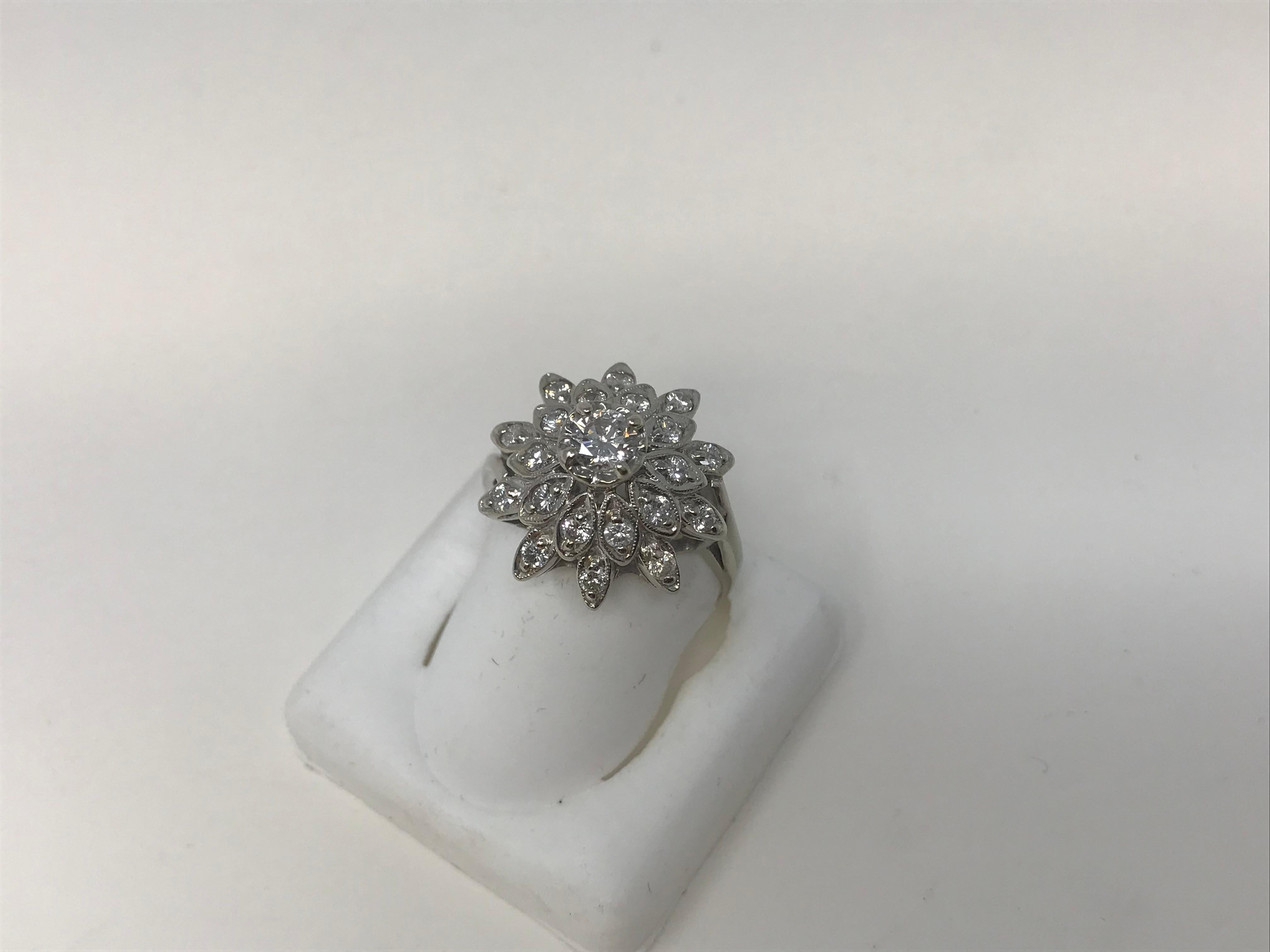 14k White Gold ladies cluster ring. The ring is set with one central brilliant cut diamond .33ct (4.5-4.54mm), purity I, color H-I, good cut. Plus 20 round cut diamonds weighing .35ct, each a total of .70ct average diameter of 2.10mm purity SI2-II,