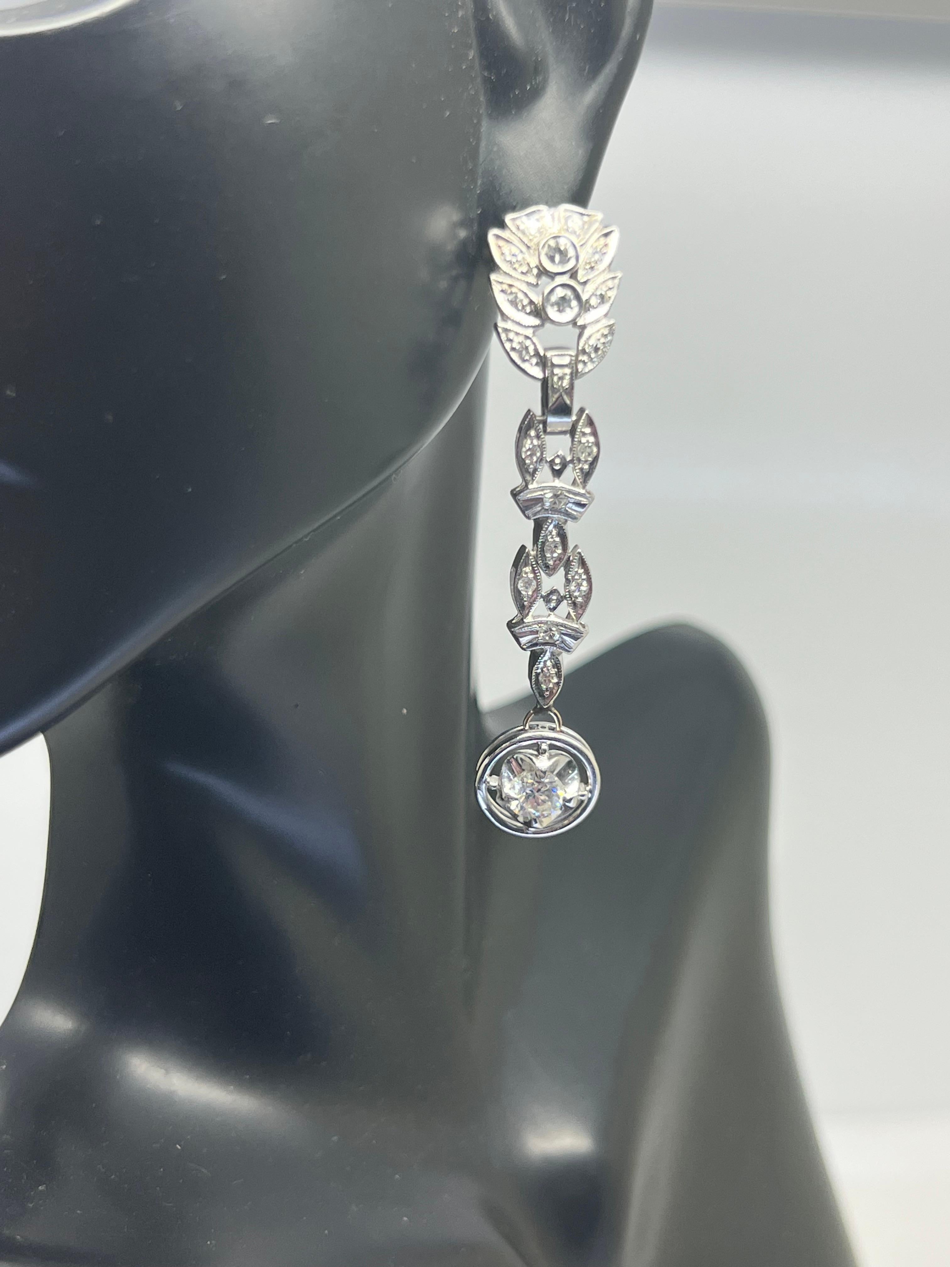 Elevate your style with these stunning 14k white gold leaf-shaped earrings featuring natural round diamonds with a total carat weight of 1.17. The intricate prong setting style showcases the white diamonds, which sparkle beautifully in the light.