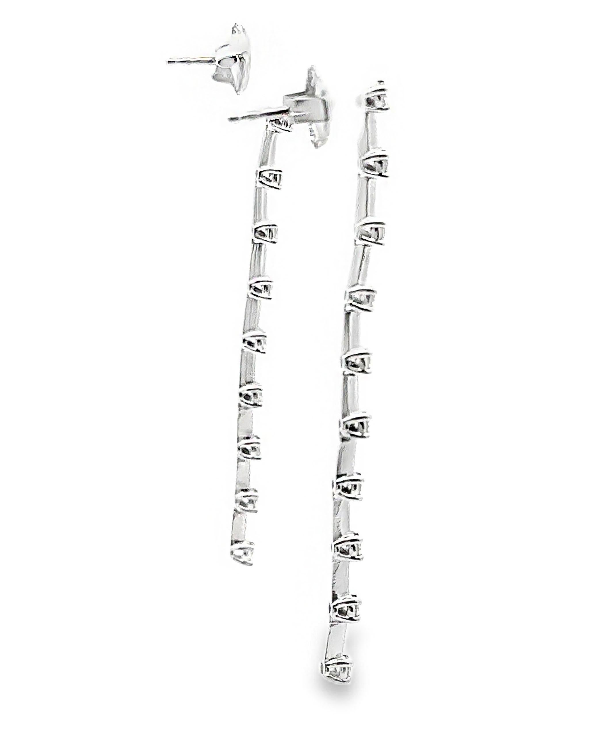 14K white gold linear stiletto earrings with 20 round faceted diamonds weighing 0.70 carats total.   

- 2 inches long
- Push back closure