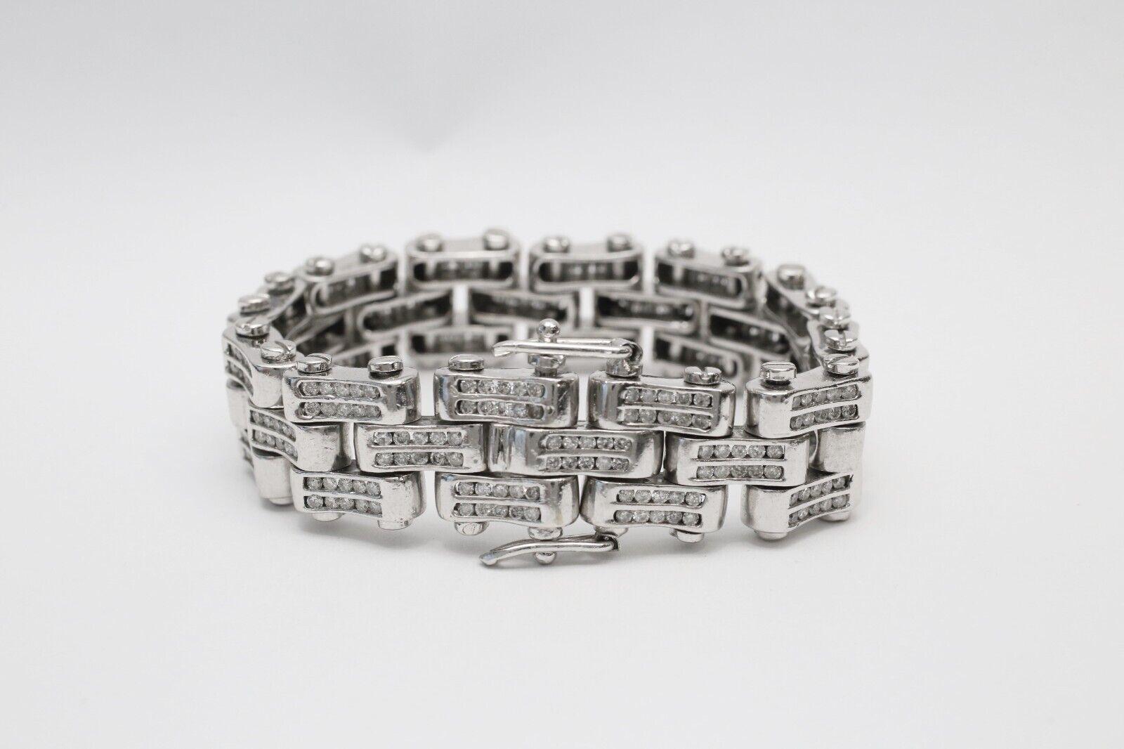 This bold 14k white gold bracelet features a substantial, industrial-inspired design with three rows of interlocking links, each set with rows of brilliant round-cut diamonds. The polished white gold adds a sleek, modern finish, while the pavé-set