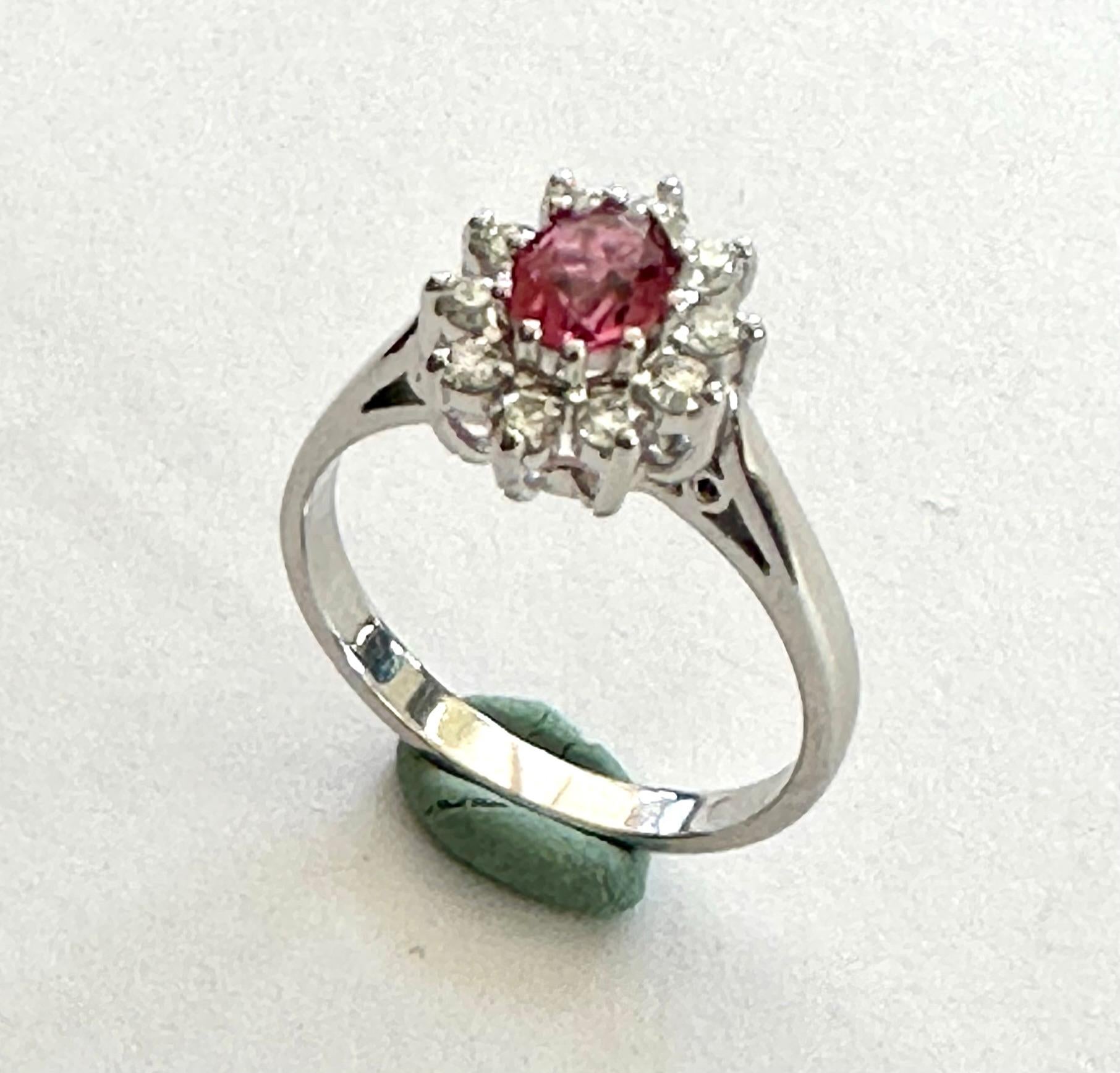 A 14K. white gold entourage ring
1 natural tourmaline (pink tourmaline) due to 0.50 ct, oval cut, color intense pink (nice quality)
10 brilliant cut diamonds of 0.03ct SI/G each
Ring in new condition.
Size: 17.25 (54) USA: 7- UK: N+
Weight: 4.03