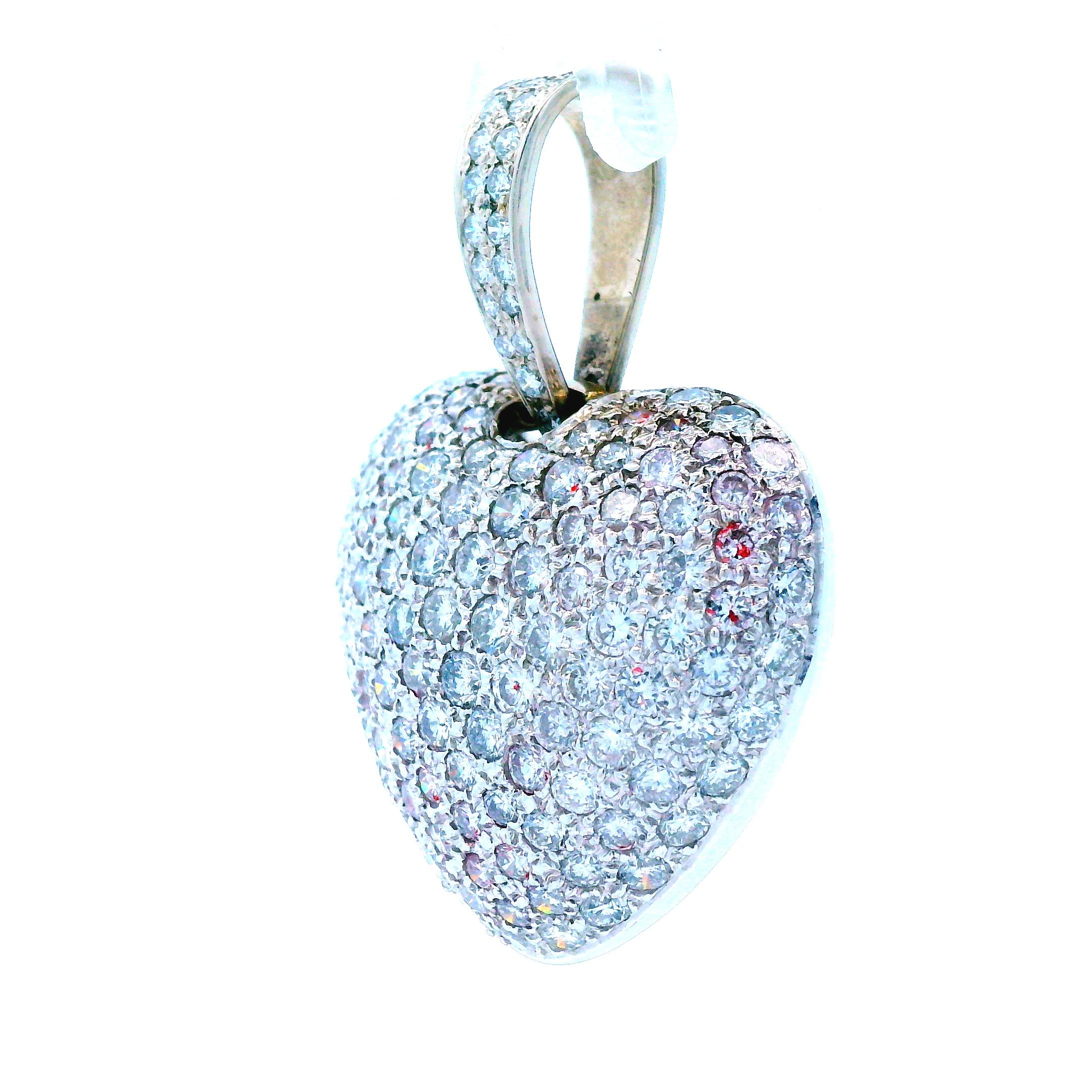 This fun and lovely pendant made in 14k white gold is a diamond pave puffy heart. With over 6.5 carats of round cut, VS2 clarity, G color diamonds, this pendent sparkles brightly and will not go un-noticed. The articulated bail also features