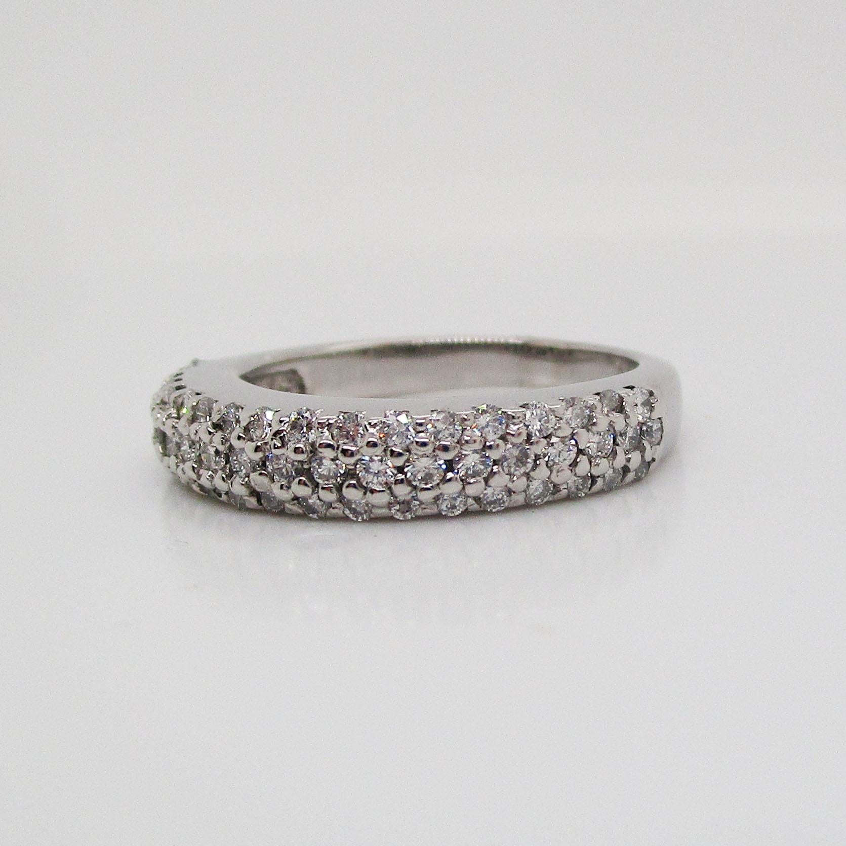 This is a beautiful classic band in 14k white gold with a stunning array of brilliant white diamonds set in an almost pave style. The band is a half-band, meaning the stones are only set on the front half of the ring and the diamonds are always face