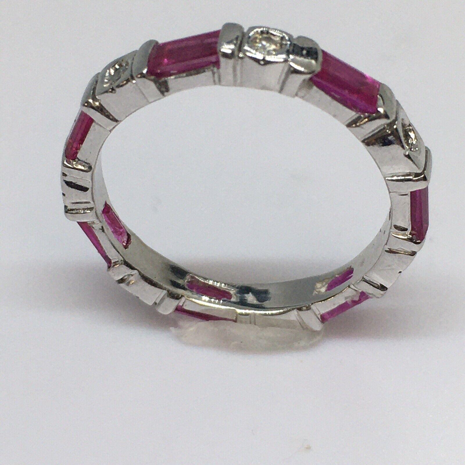 14K White Gold Diamond Ruby eternity band

3mm wide
Weighting 2.5 gram
7 pieces natural Rubies 4mm by 2mm Baguette cut
7 pieces 1 Millimeter Earth Mind Diamonds
Finger size 5.25
