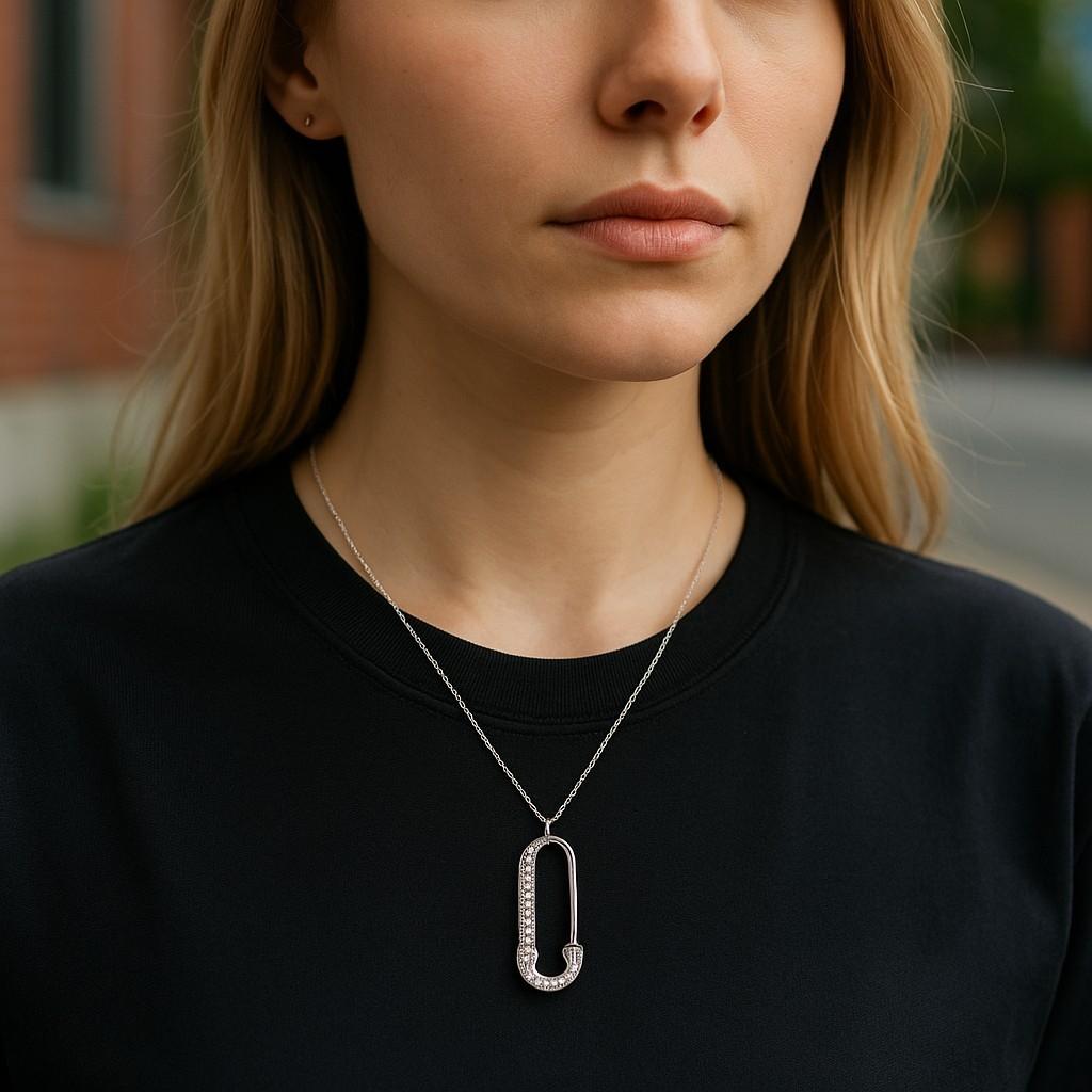 Bold yet elegant, this 14K White Gold Diamond Safety Pin Necklace is the ultimate fusion of luxury and edge. Crafted in luminous 14K white gold and weighing a delicate 1.4 grams, this necklace showcases a unique safety pin pendant adorned with 0.20