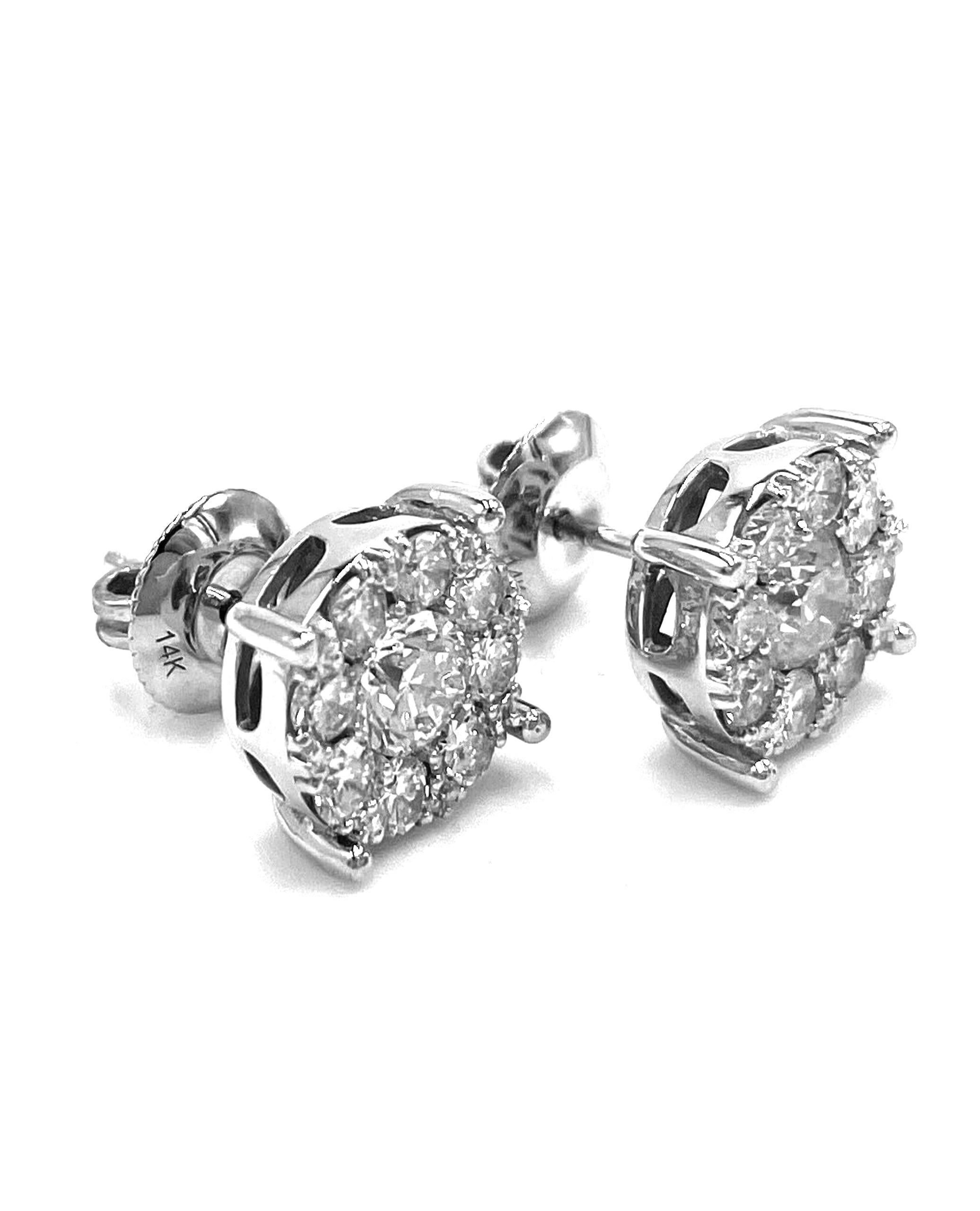 Pair of 14K white gold cluster stud earrings with 16 round, brilliant-cut diamonds 0.96 carat total weight and two round, brilliant-cut center diamonds 0.73 carat total weight.

* Diamonds are G/H color, VS2/SI1 clarity.
* Push back closure.
