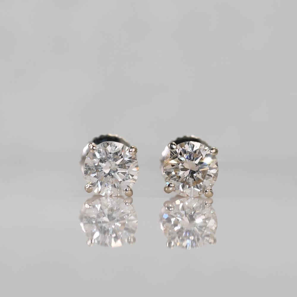 Diamond stud earrings in 14k white gold settings.
Stamped 585 and weigh 1.3 grams gross weight.
The diamonds are round brilliant cuts, 1.20 total carats, J to K color, Si to i1 clarity, good cuts.
Screw backs for pierced ears.
Excellent condition. 