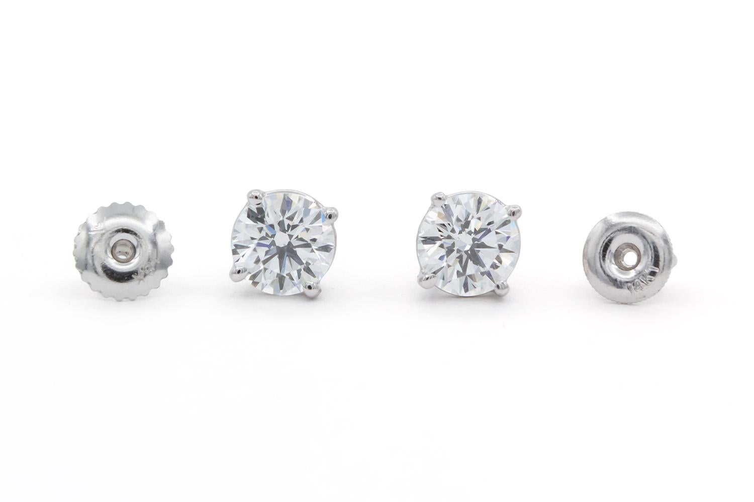 We are pleased to present these 14K White Gold & Diamond Stud Earrings. These beautiful set of stud earrings feature 1.80ctw E-F/VS1-VS2 Round Brilliant Cut Diamonds set in 14k White Gold studs with screw back setting. The diamonds have lots of