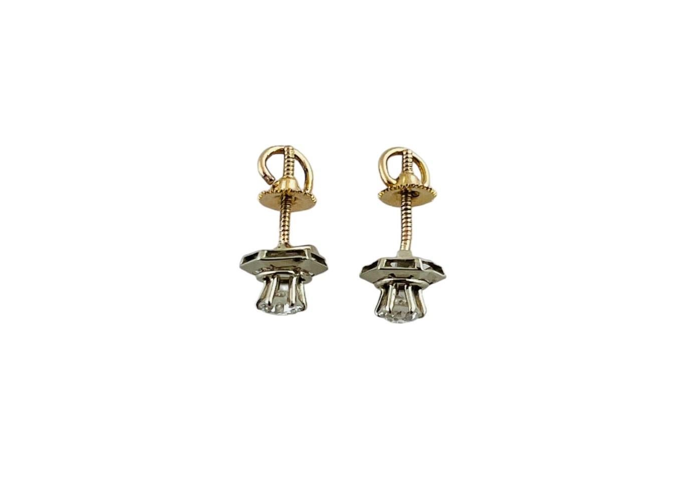 These vintage diamond stud earrings are each set with one round brilliant diamond.

Behind each diamond is a hexagon jacket of 14K white gold

Screw back posts. 14K yellow gold backs.

Diamonds are each approx. 0.25 carats - approx. .50 cts total