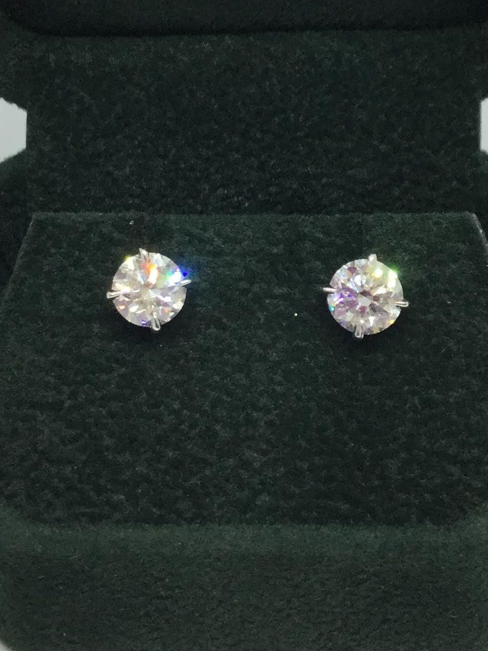 14K white gold diamond studs. Diamonds weigh 2.04 ctw H/SI2. Diamonds are set in a wire basket setting with friction posts.