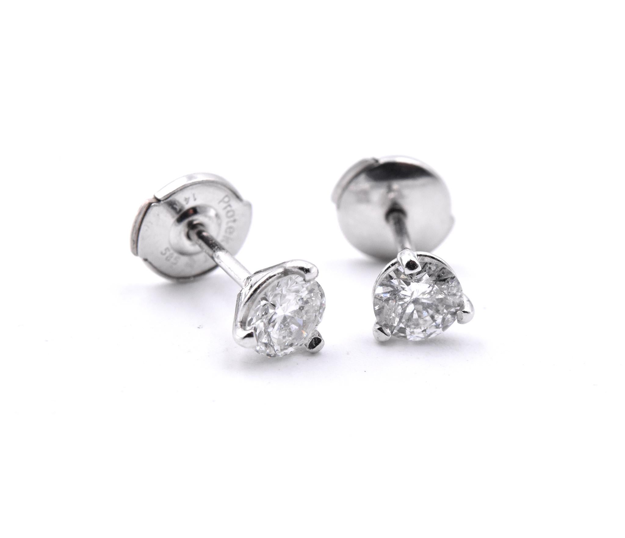 Material: 14K white gold
Diamonds: 2 round brilliant cuts=.64cttw 
Color: H
Clarity: SI2
Dimensions: earrings measure 5.00mm in outer diameter
Fastenings: posts and locking backs 
Weight: 1.03 grams
