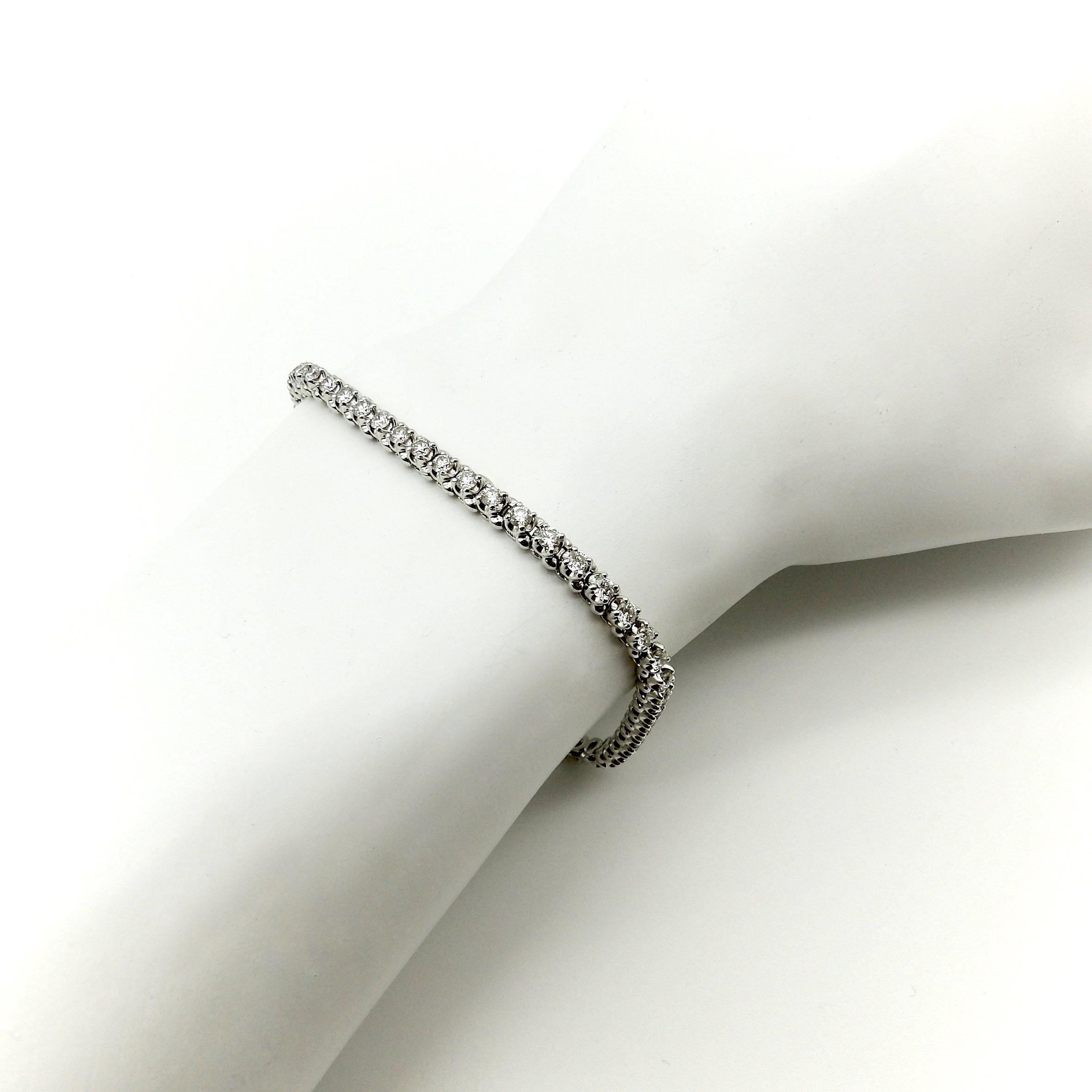 This 14k white gold tennis bracelet features 54 gorgeous round brilliant-cut diamonds. The tennis bracelet, also referred to as a line bracelet, was a popular style in the Art Deco era—a classic look that’s been around for a long time and is always