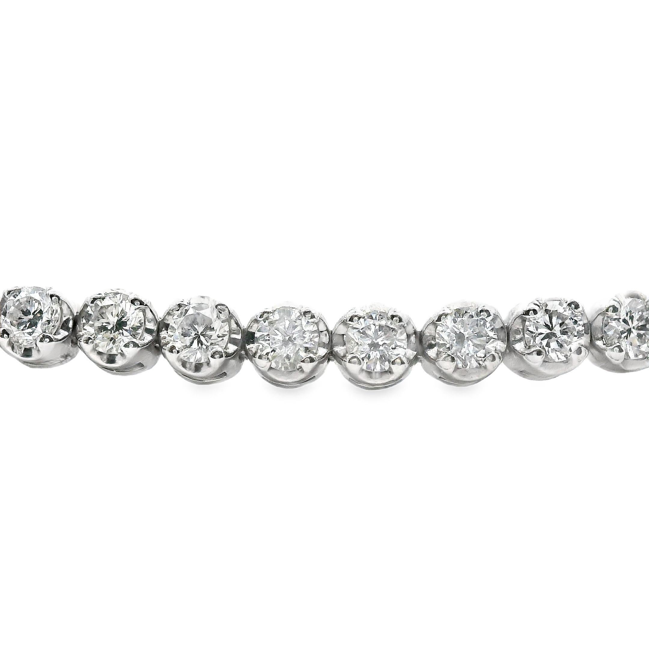 This is a beautiful white gold and diamond tennis bracelet, made in 14k yellow gold. This tennis bracelet is size 6.75, comes with an independent appraisal and is in excellent condition. Being about 2mm in size and having 1.74 carats, this tennis
