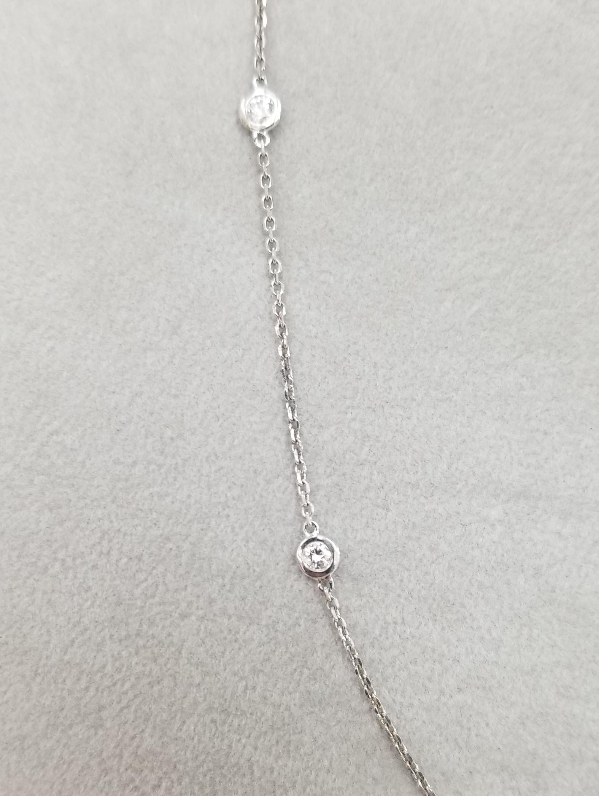 14k white gold diamonds by the yard necklace, containing 10 round full cut diamonds of very fine quality weighing .70pts. on a 18 inch chain.