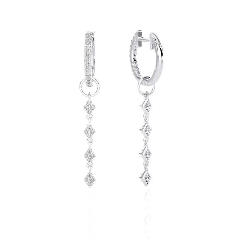 Unveil a world of distinctive elegance with our 14K White Gold Diamonds Huggie Earrings. A true marvel, these earrings feature a remarkable 0.4 carats, distributed across 58 individual diamonds, each a testament to precision and grace. The huggie