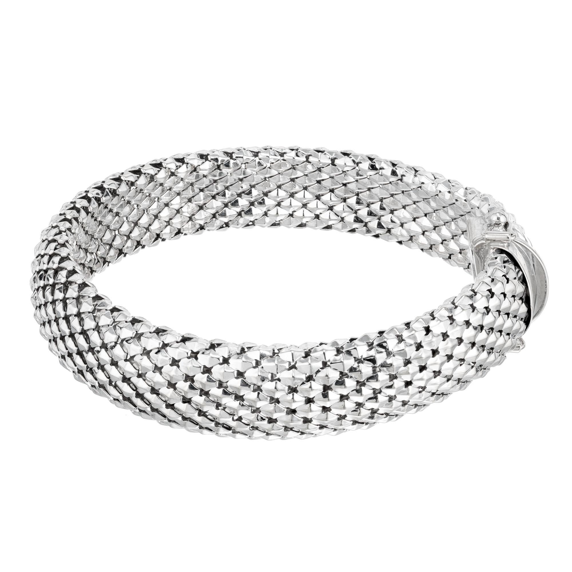 Domed shiny weaved 14k white gold bracelet with double side lock and double figure 8 safety. 7.5 Inches long. The intricate weave design showcases intricate craftsmanship, making it a timeless and versatile accessory. 

14k white gold 
Stamped: