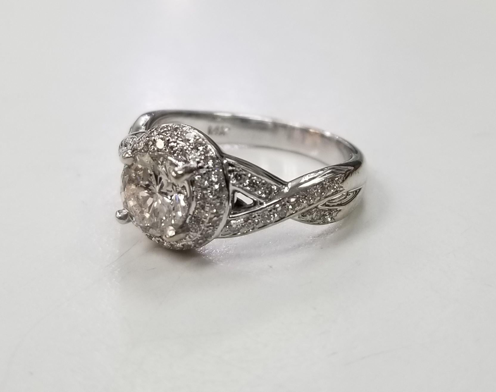 14k white gold double halo ring, containing 1 brilliant cut diamond; color