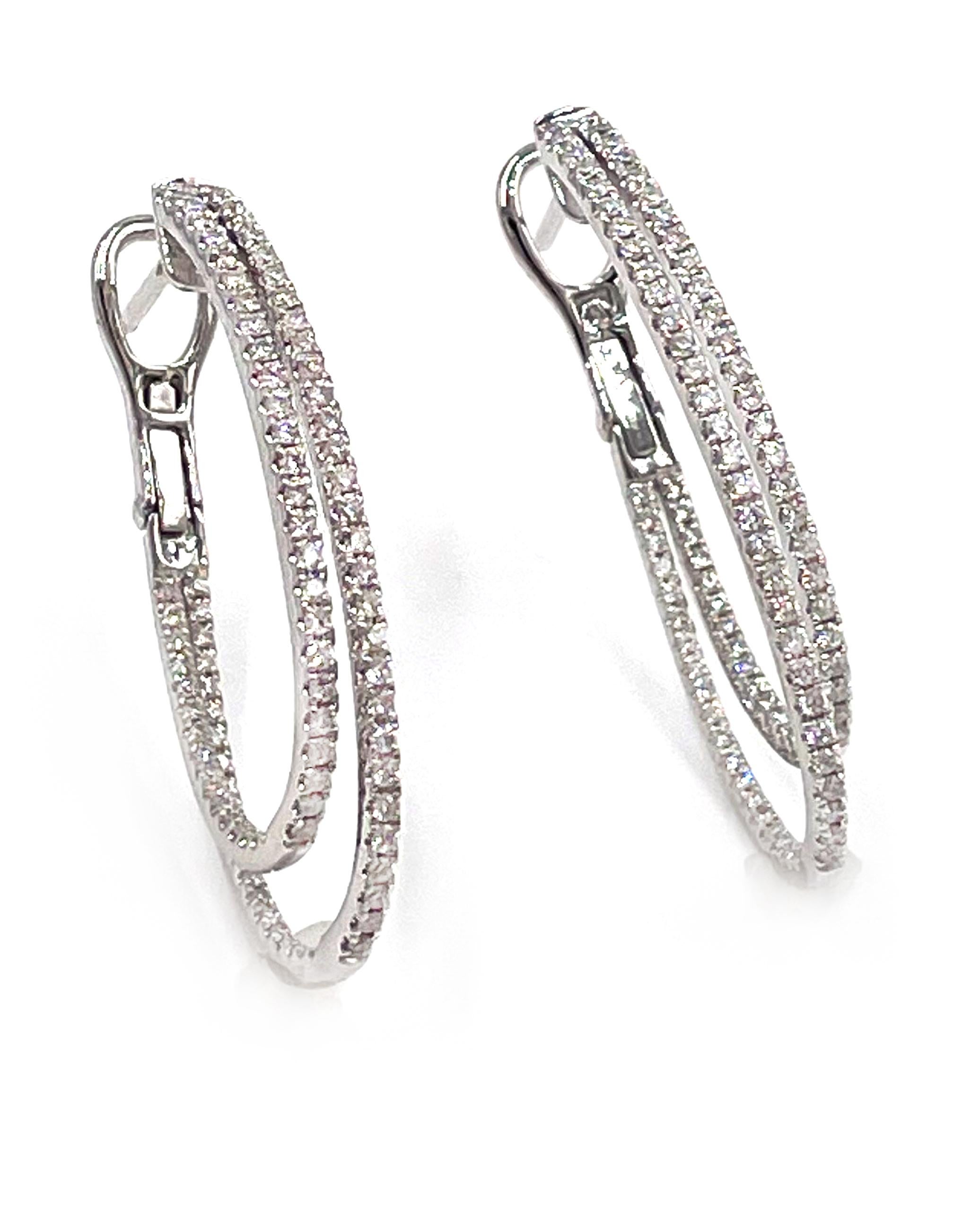 14K white gold double row hoop earrings with French backings.  The earrings are prong set with round, brilliant-cut diamonds weighing 0.95 carats total. 

- The diamonds are on average G/H color, VS2/SI1 clarity
- 1.25 inches in length
- 3.2mm in