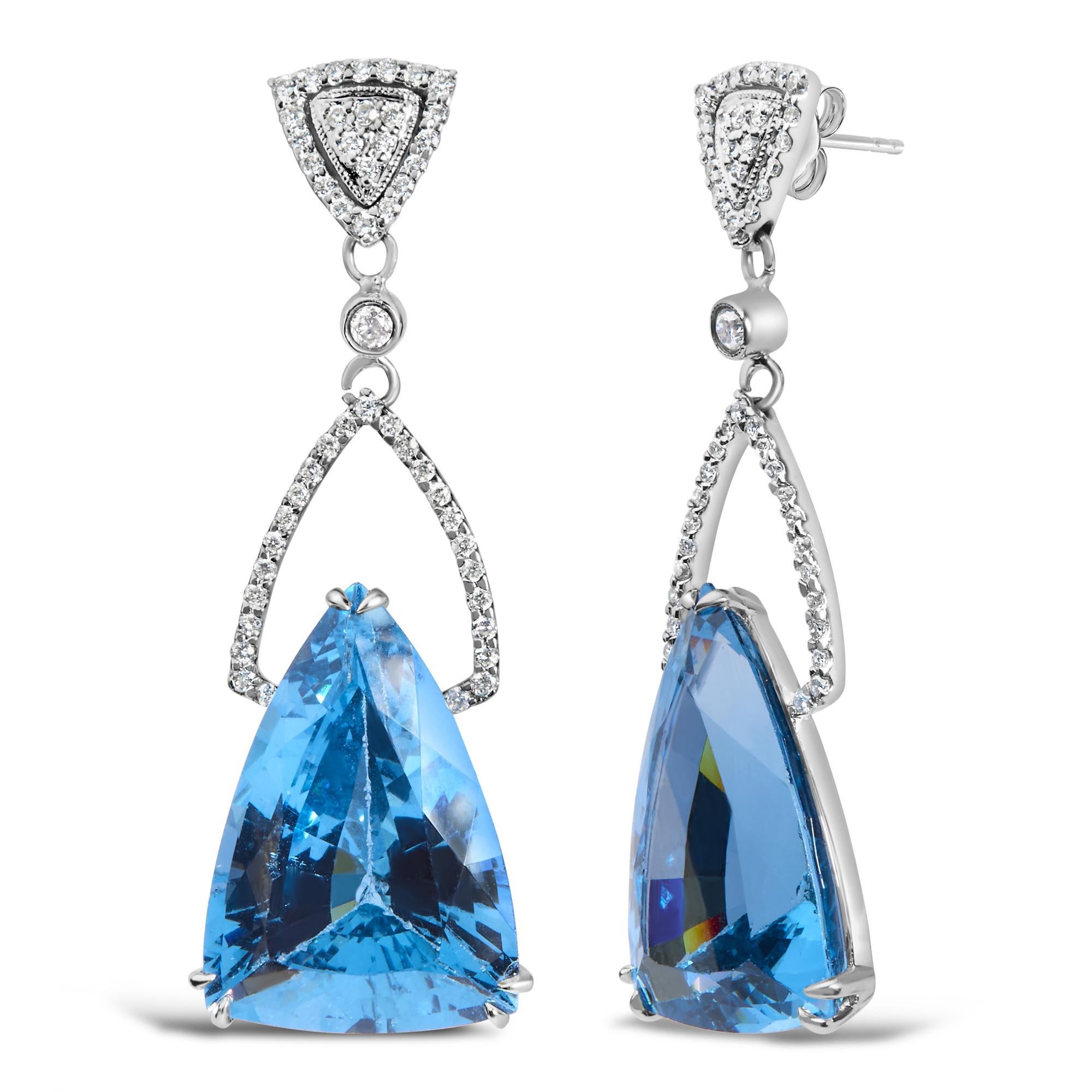 Embodying elegance and a shimmering cascade of color, these 14K white gold earrings are a testament to exquisite craftsmanship. Rhodium-plated for an extra touch of radiance, each earring features a spellbinding trillion-cut blue topaz, with its