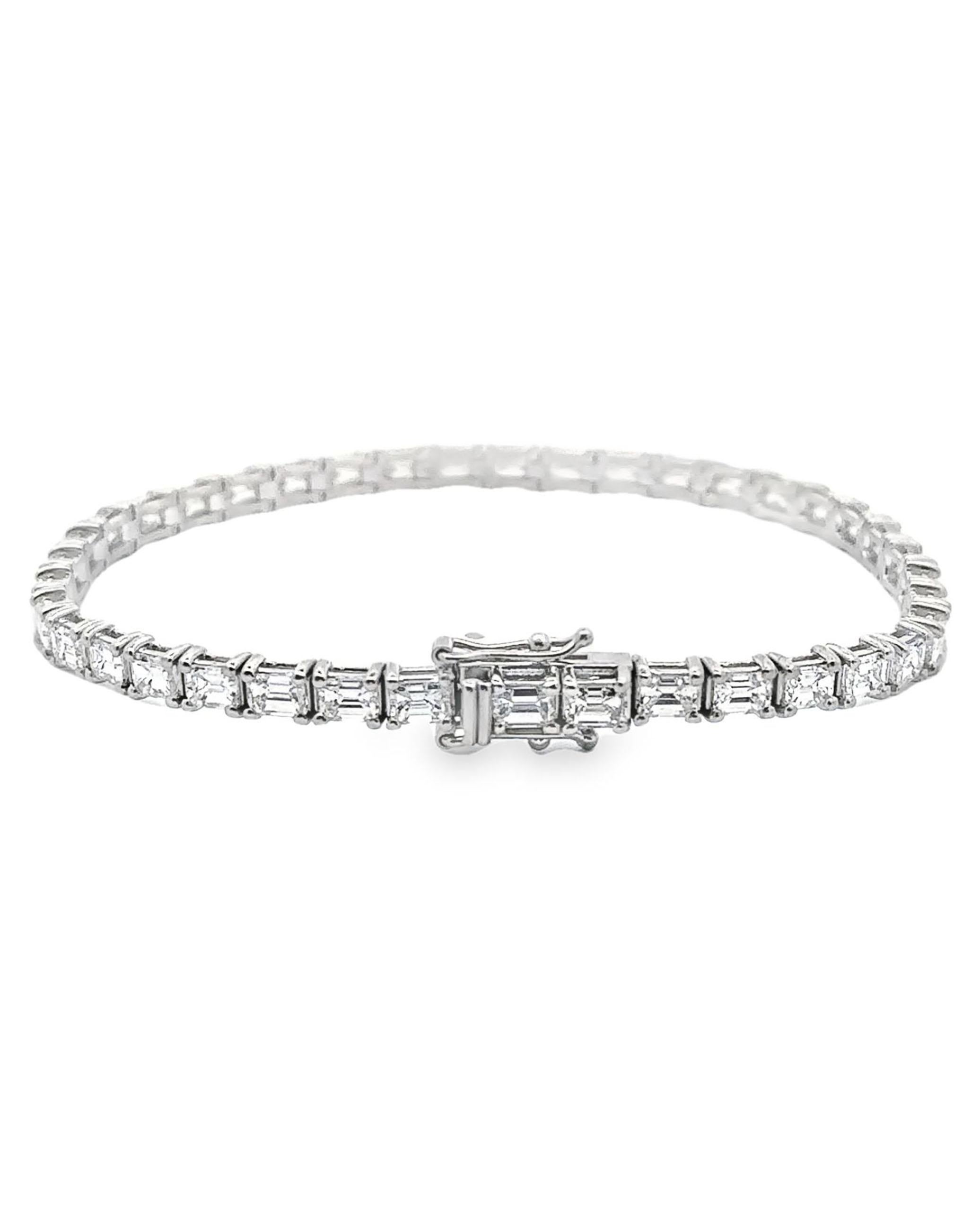 14K white gold line bracelet furnished with 39 emerald-cut diamonds weighing 8.15 carats total. 

* Diamonds are G/H color, VS2 clarity.
* 7 inches long.
* Double figure 8 safety lock.