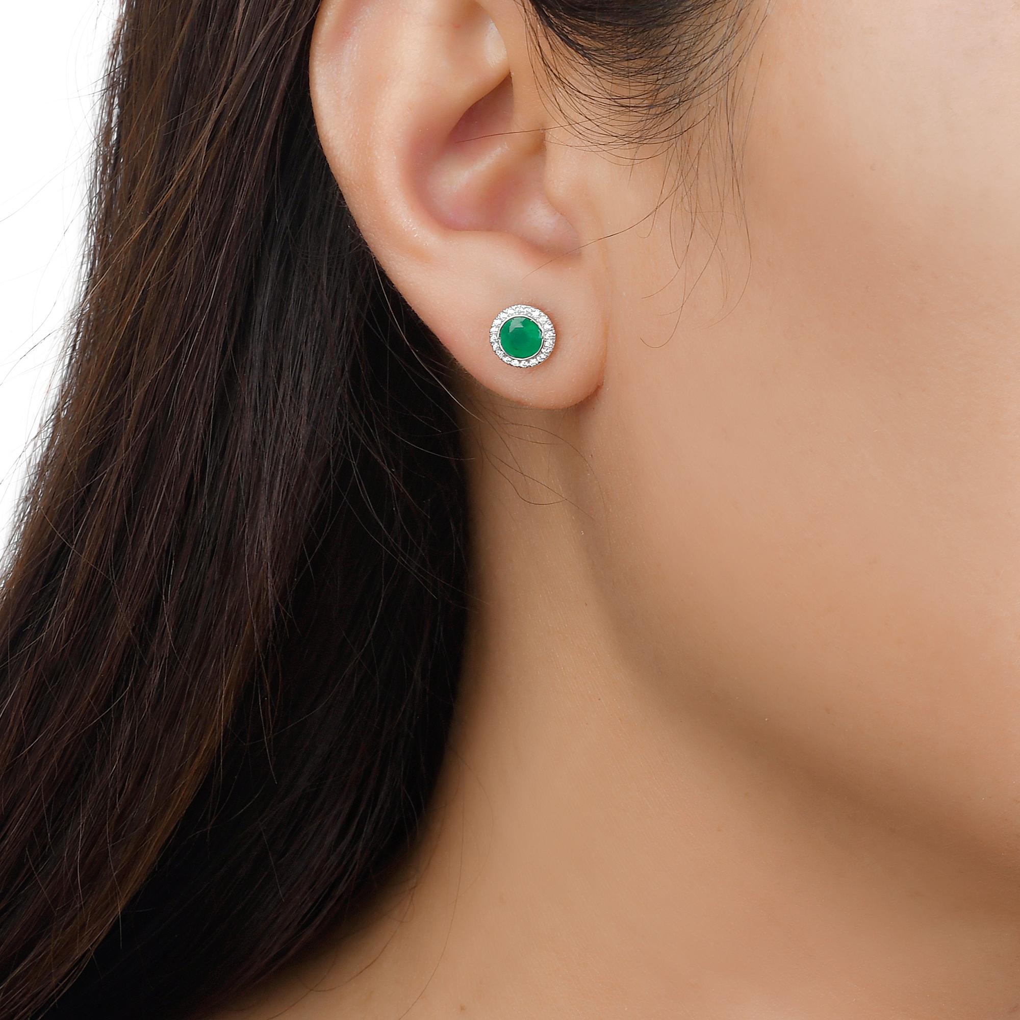 Indulge in luxury with our Emerald and Diamond Halo Stud Earrings in 14K White Gold. Featuring stunning round emeralds, these emerald stud earrings exude sophistication and exclusivity. The dazzling halo design with accompanying diamonds adds an