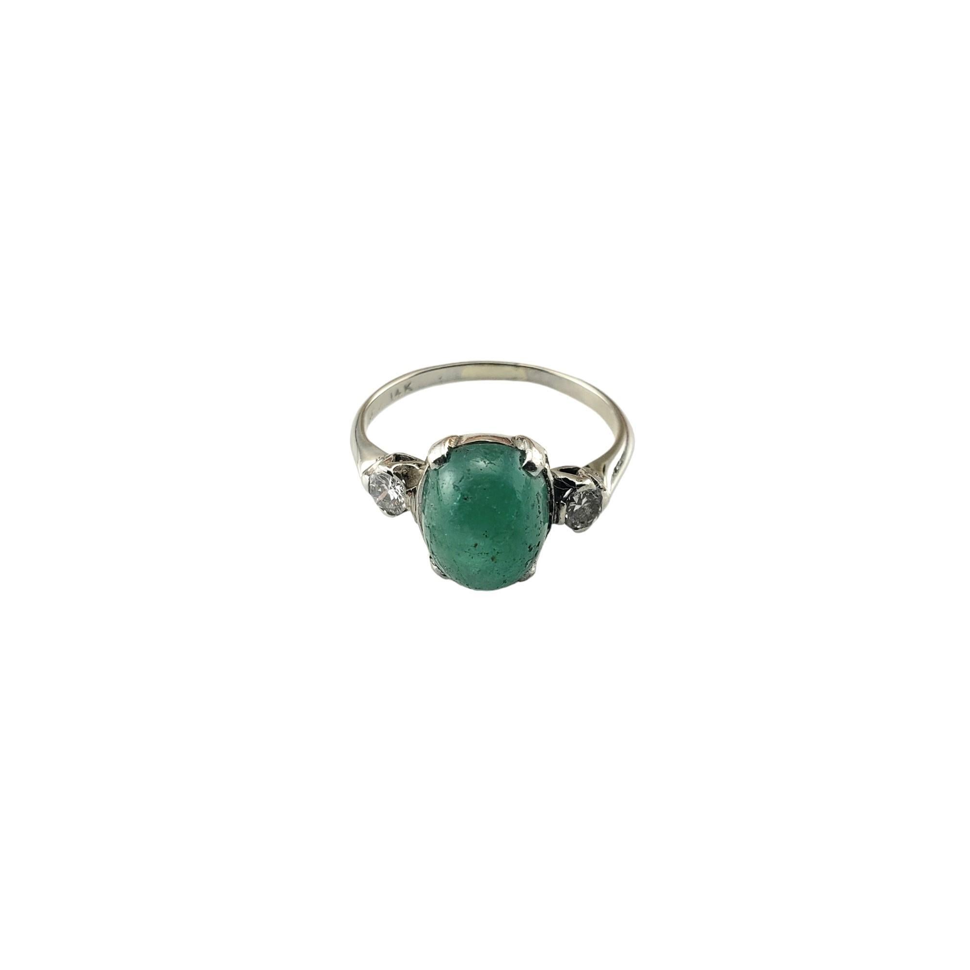 Vintage 14 Karat White Gold Emerald and Diamond Ring Size 4.5 JAGi Certified-

This elegant ring features on oval cabochon emerald (8.8 mm x 7.2 mm) and two round brilliant cut diamonds set in classic 14K white gold.  Shank: 1.4 mm.

Emerald weight: