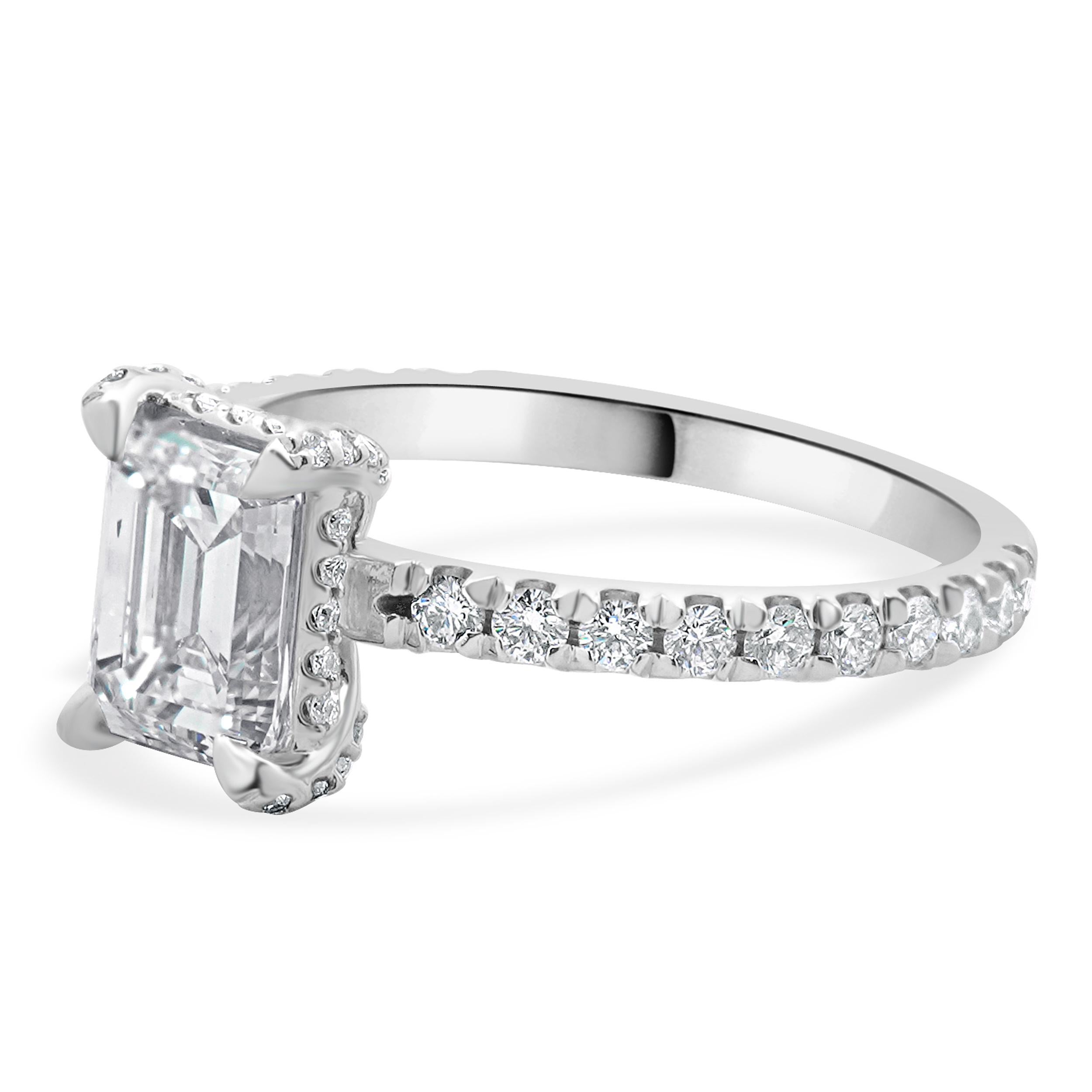 Designer: custom
Material: 14K white gold
Diamond: 1 emerald cut = 1.26ct
Color: I
Clarity: VVS2
Diamond: 52 round brilliant = 0.92cttw
Color: H
Clarity: SI1
Ring Size: 6.5 (complimentary sizing available)
Weight: 2.88 grams
