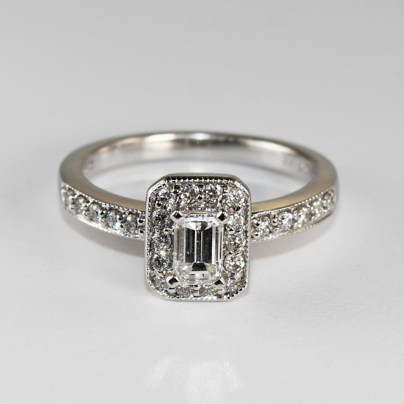 Emerald cut diamond ring set in 14k white gold.
Stamped 14kt, .47, and weighs 6.8 grams.
The center diamond is an emerald cut, .47 carats, G to H color, Si2 clarity, and good cut.
The side diamonds on the engagement ring and wedding band are round