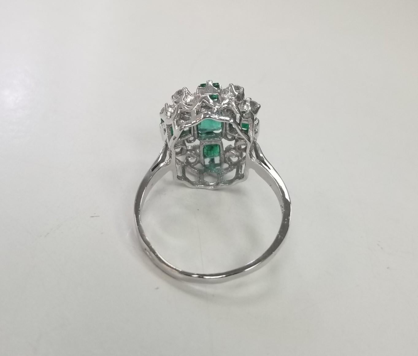 Contemporary 14k White Gold Emerald Cut Emerald and Diamond Cluster Ring For Sale