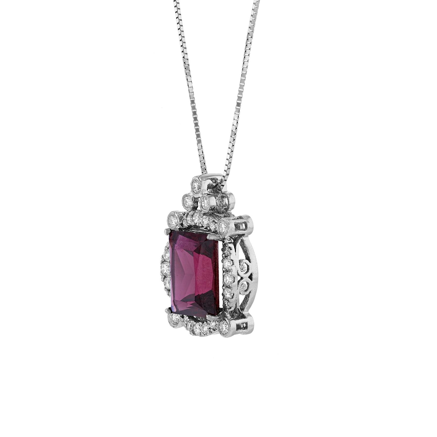 This pendant necklace is made in 14K white gold. It features a emerald cut Garnet weighing 10.76 carat. Surrounded by 27 round cut diamonds weighing 0.87 carat. All stones are prong set. The necklace has a color grade (H) and clarity grade (SI2). 