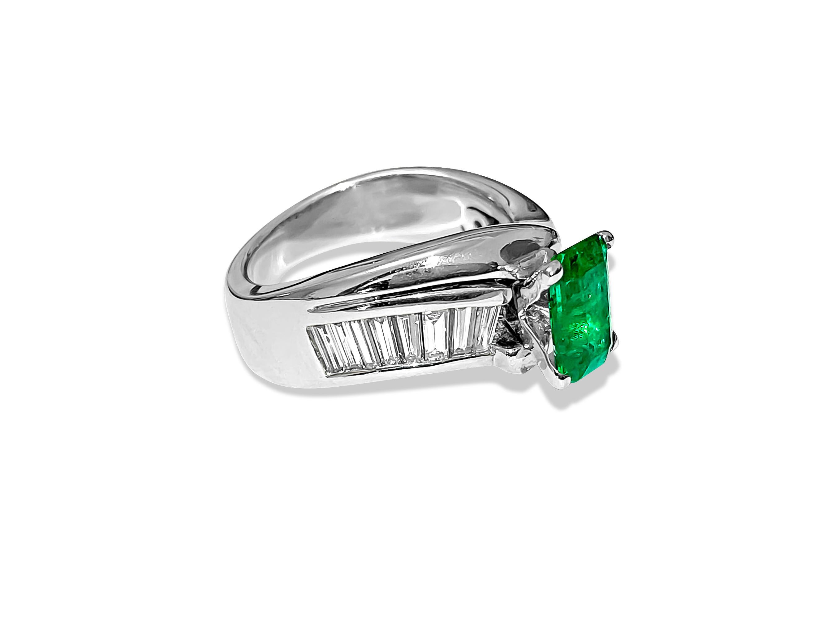 Crafted from solid 14k white gold, this exquisite engagement ring features a stunning 2.00-carat emerald center stone, showcasing excellent color and saturation in an emerald cut and set securely in prongs. Adorning the sides are 1.31 carats of