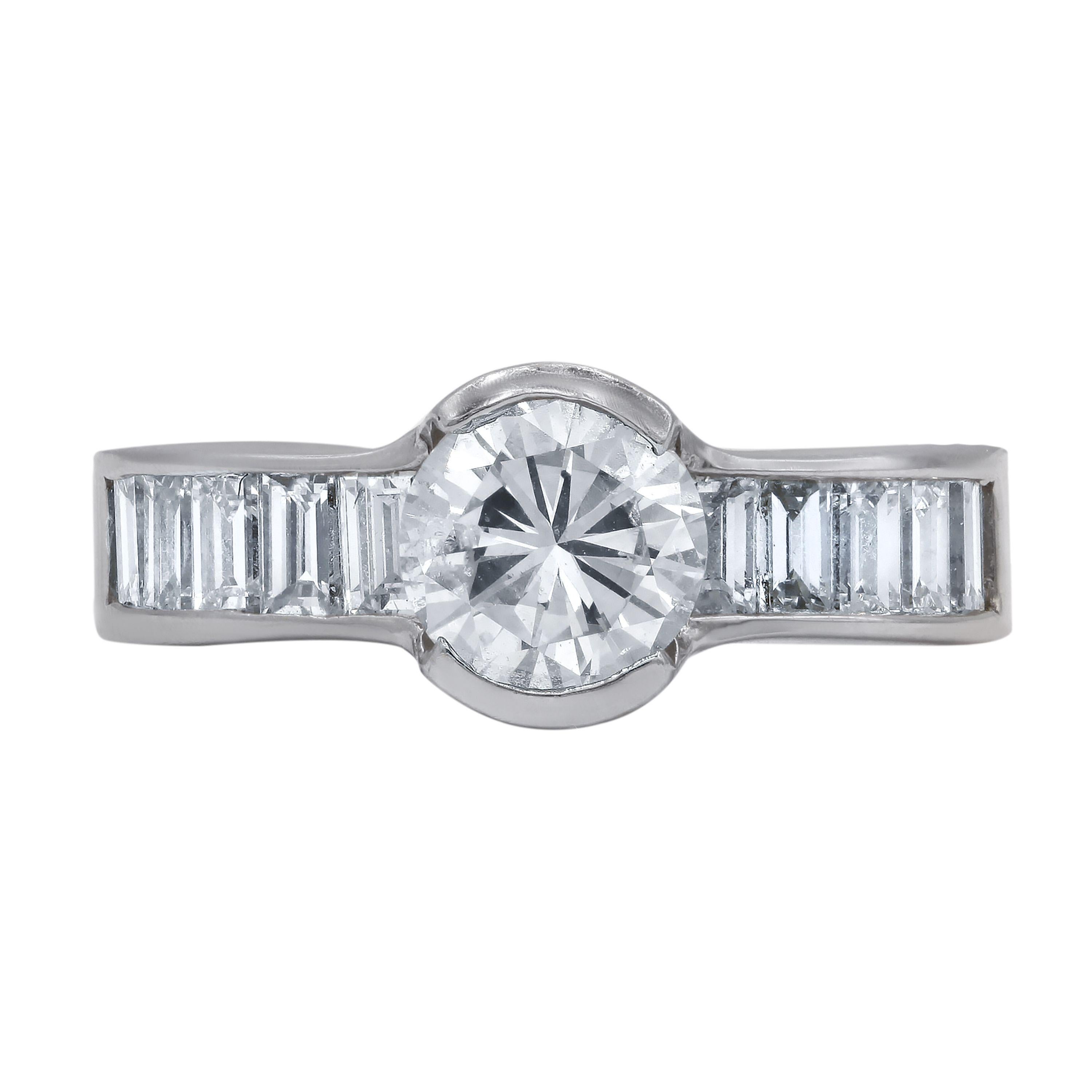 14k white gold engagement ring with main round 1.27ct stone and additional baguette diamonds in 1.25ct.
