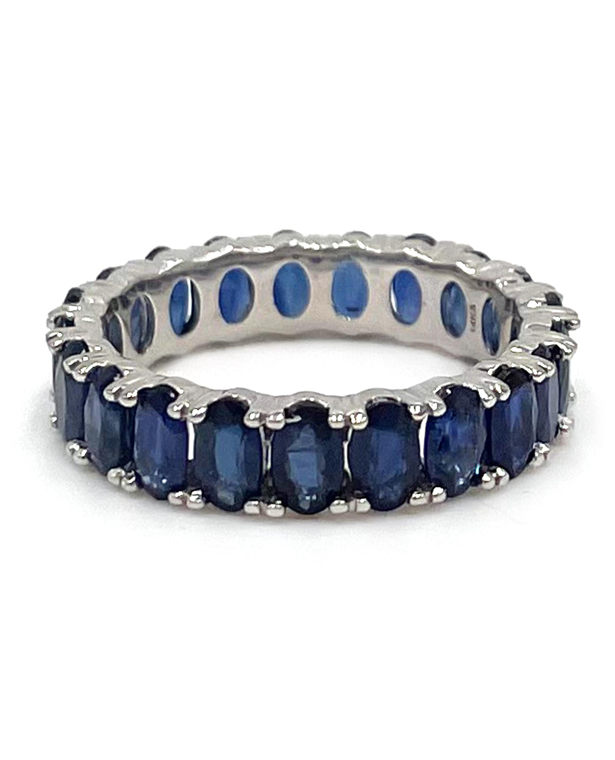 Stackable 14K White Gold Sapphire Eternity Ring with 21 Oval Shape Dark Blue Sapphires 6.03 carats.

* Finger Size 8 
* Each sapphire is approximately 5x3mm
* 5mm Wide