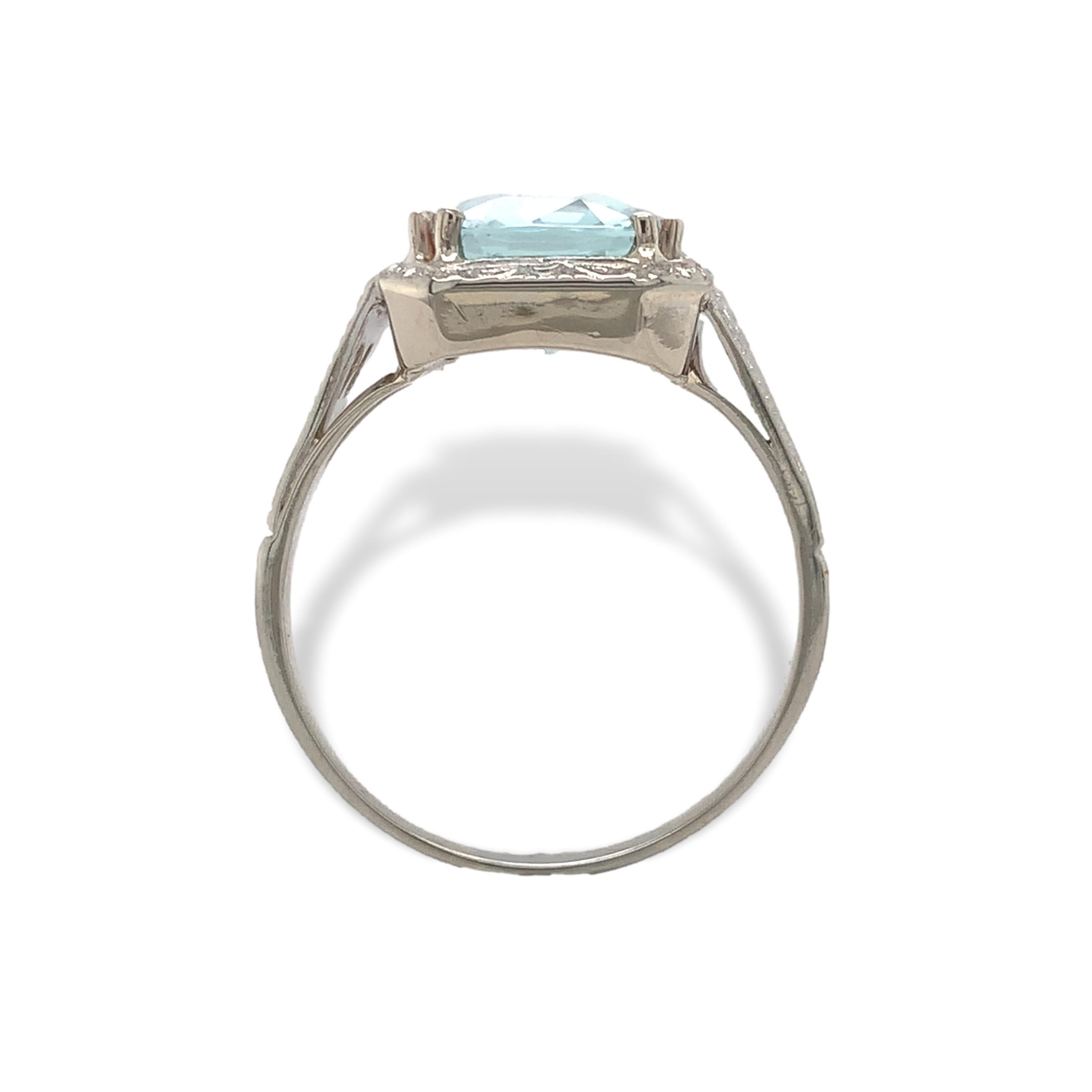 14K white gold filigree ring featuring an antique cushion cut aquamarine weighing 3.12 carats. The light blue aquamarine measures about 11mm x 9mm. The ring has filigree shoulders. The aqua is a little deep for the setting. The ring fits a size 7.25