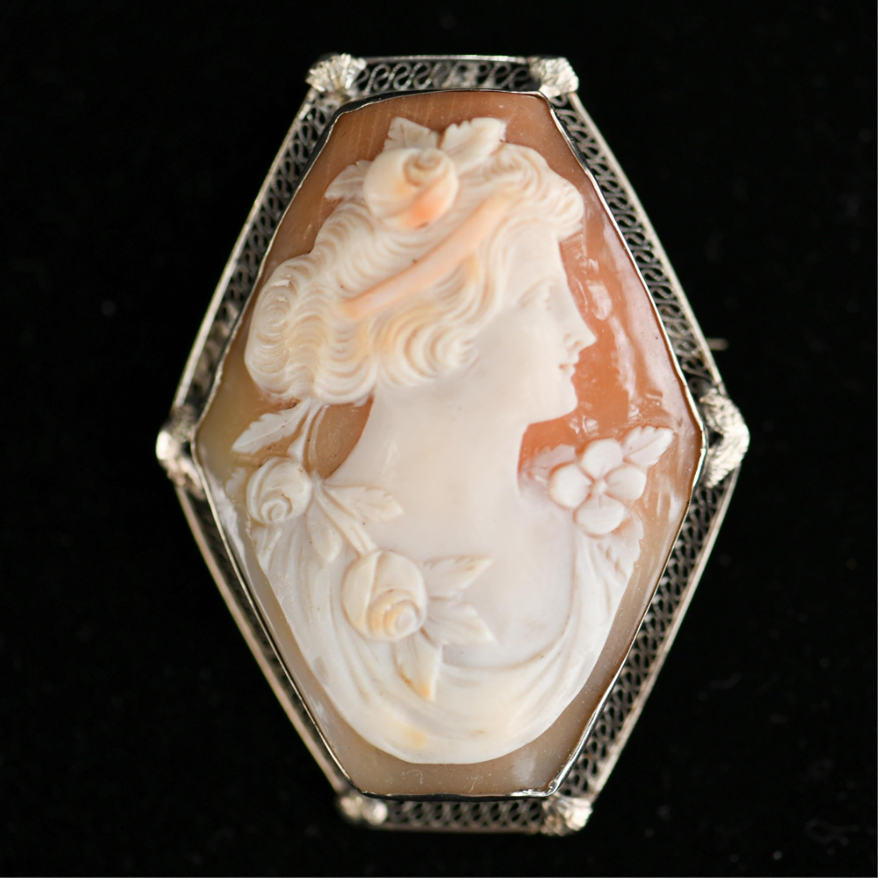 14 karat white gold filigree with nicely carved hard shell cameo.