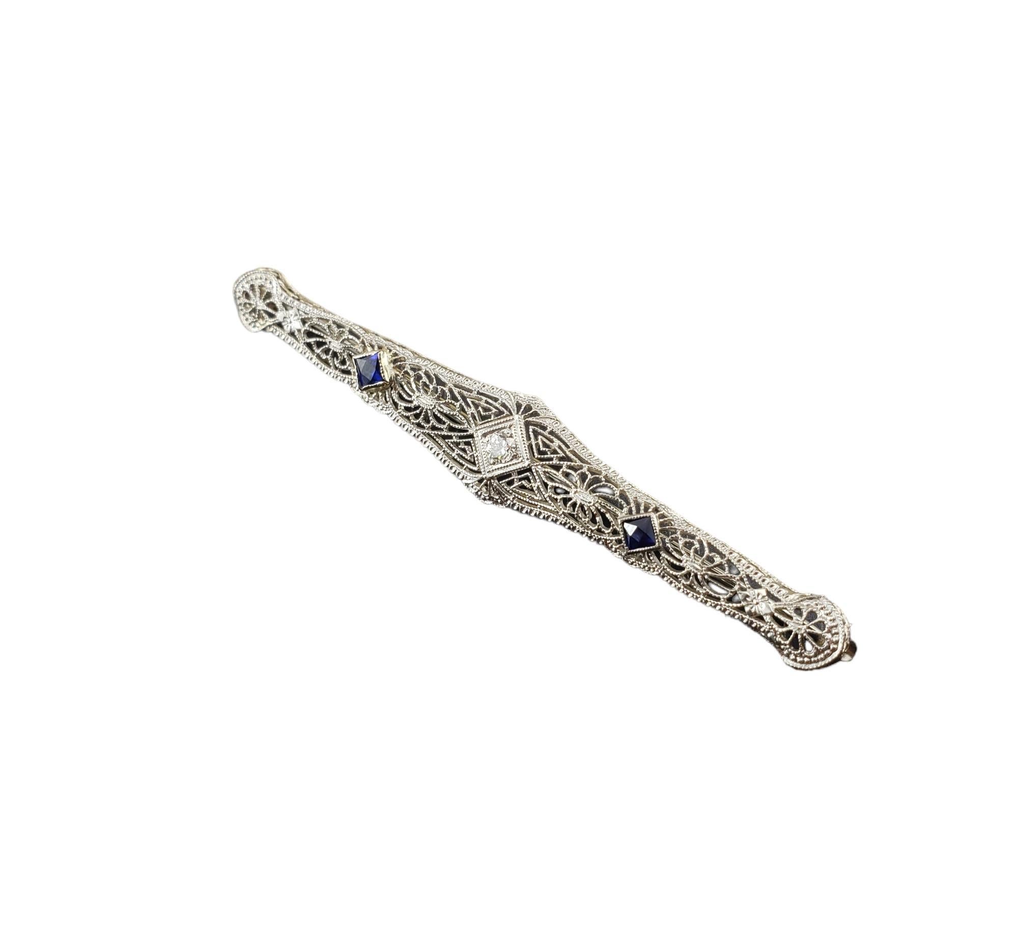 14K White Gold Filigree Simulated Sapphire and Diamond Brooch/Pin

This stunning brooch features two simulated sapphires and one round brilliant cut diamond set in beautifully detailed 14K white gold filigree.

Approximate diamond weight: .08