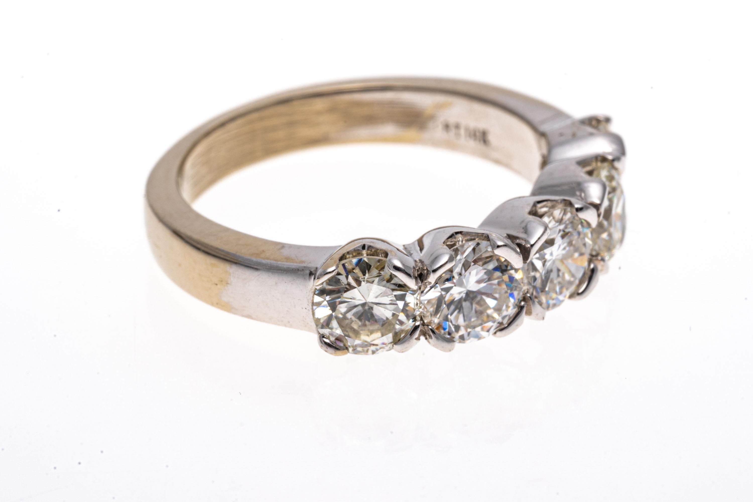 14k white gold ring. This stunning ring is a five stone band ring, set with five, round brilliant cut diamonds, approximately 1.95 TCW, VS to SI clarity, and prong set. 
Marks: 14k
Dimensions: 3/4