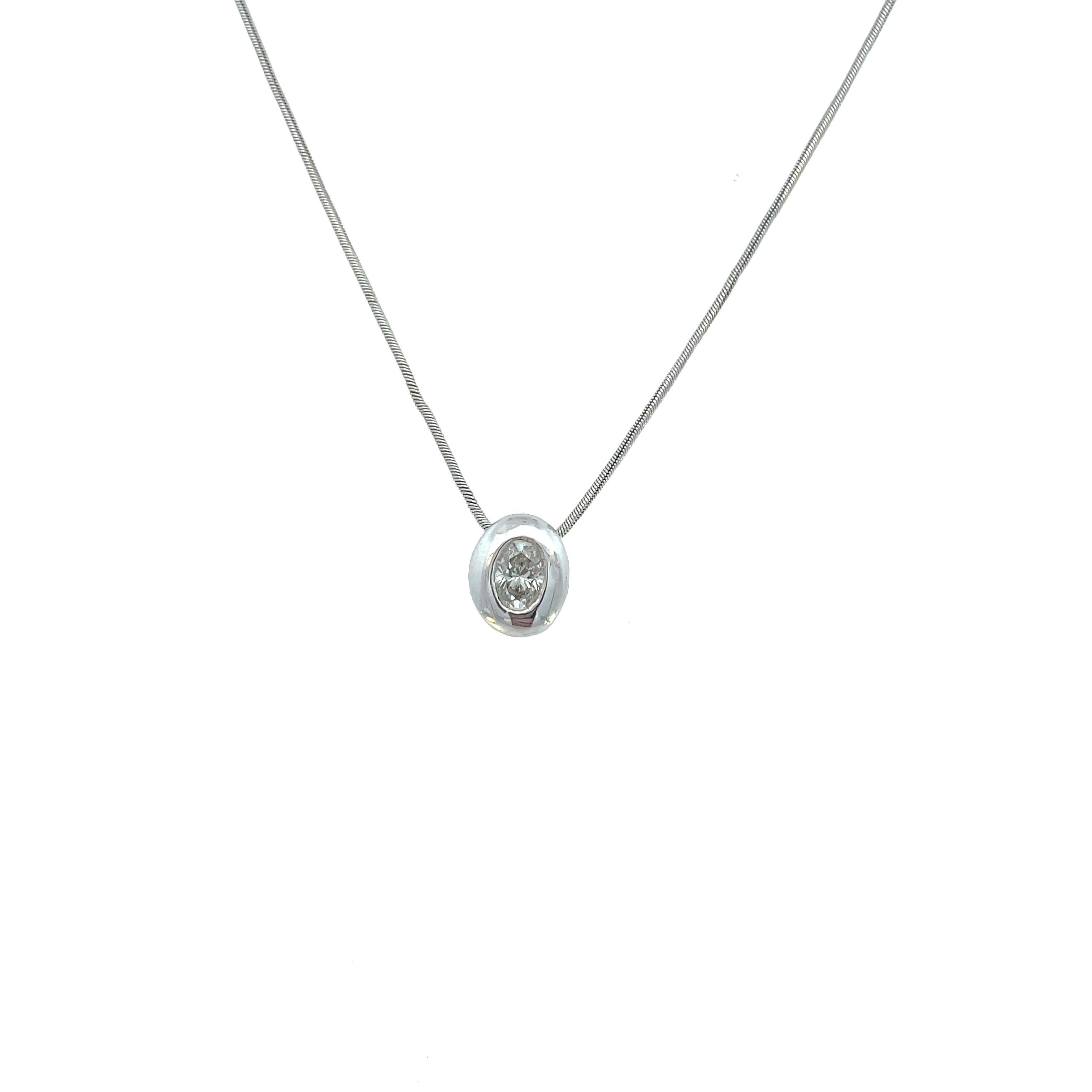 This is a classic floating bezel necklace adorned with a sparkling oval diamond at the center crafted in beaming 14K white gold. The necklace measures 20