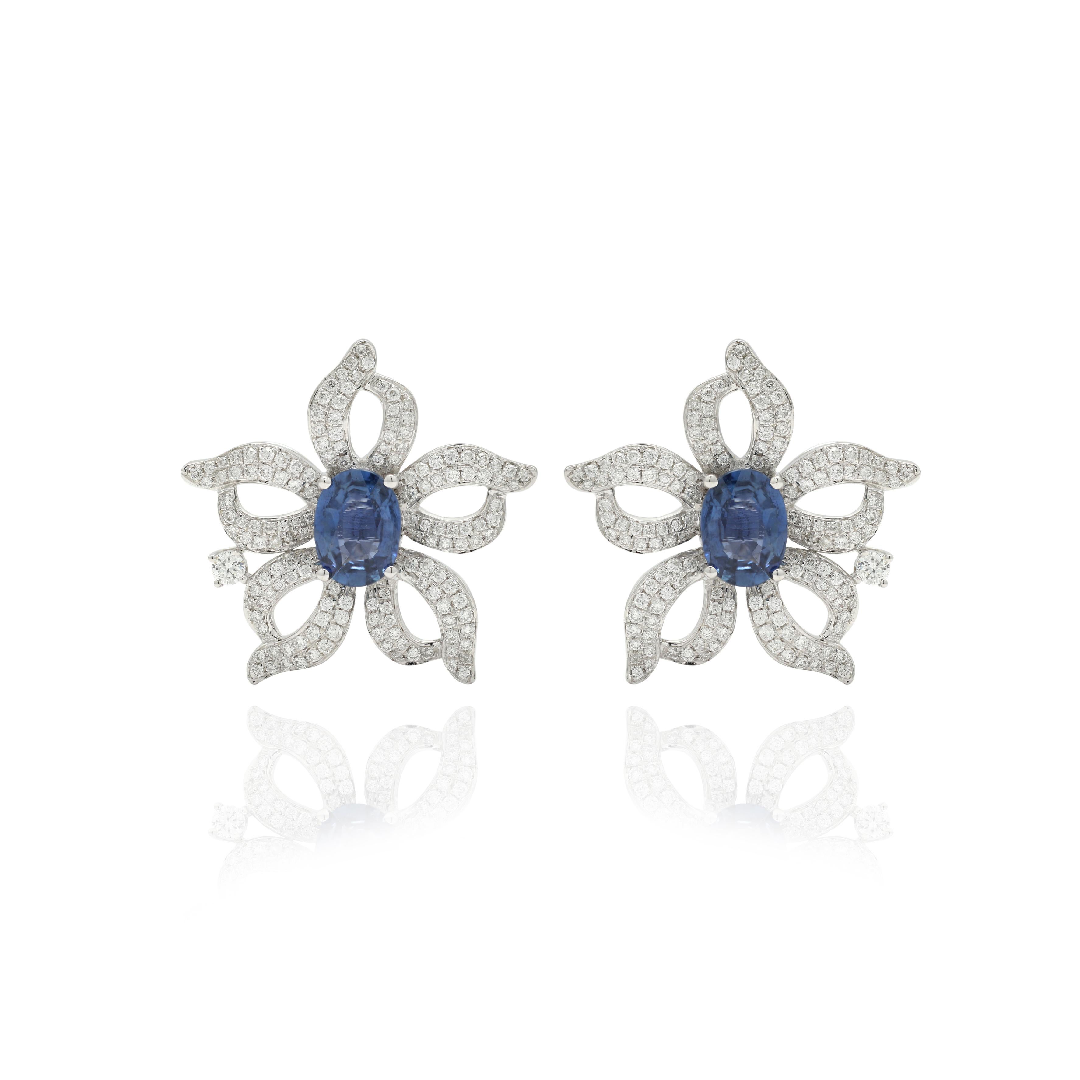 Studs create a subtle beauty while showcasing the colors of the natural precious gemstones and illuminating diamonds making a statement.
Floral blue sapphire with diamonds stud earrings in 14K gold. Embrace your look with these stunning pair of