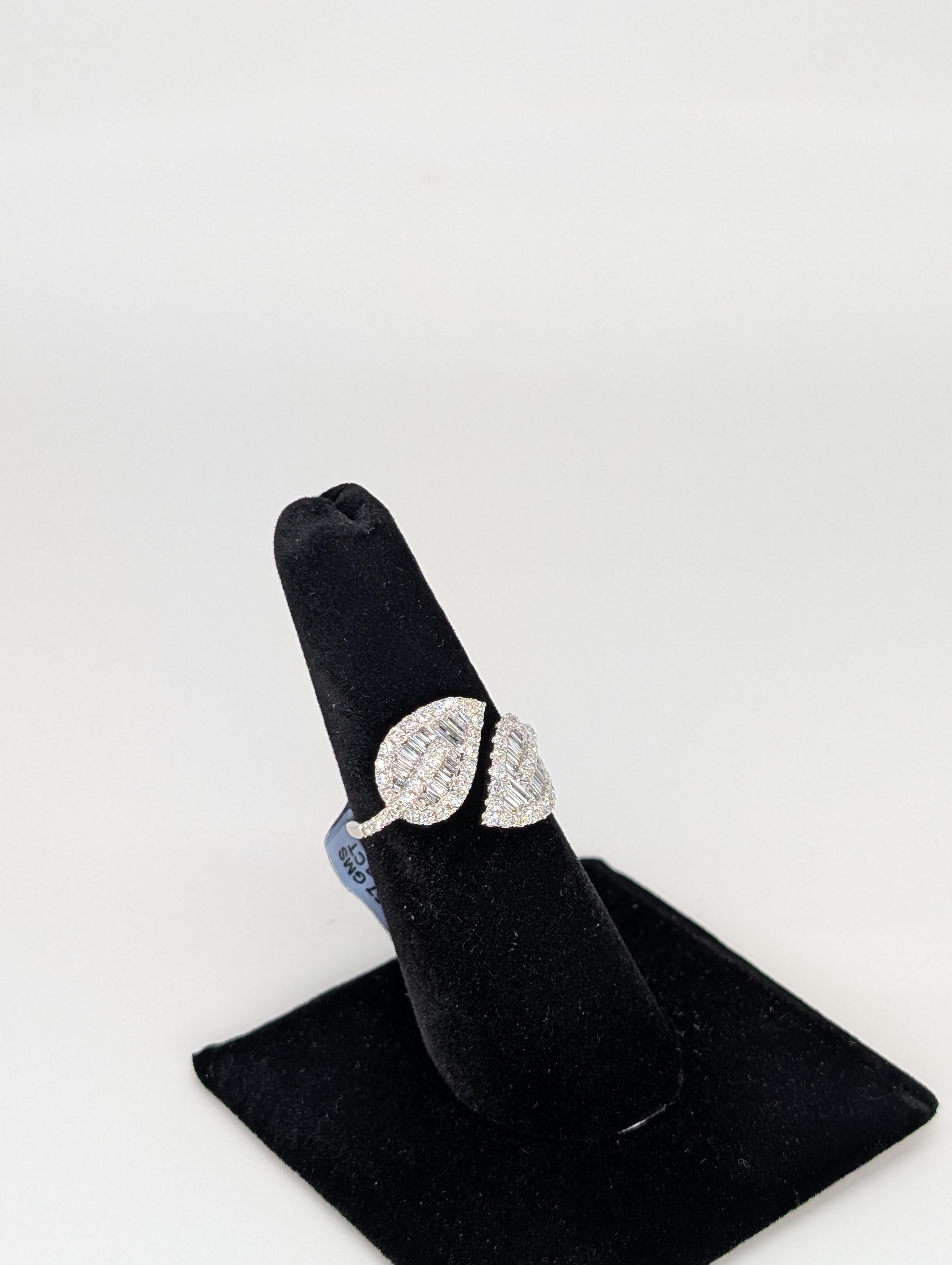 This exquisite 14-karat white gold floral leaf bypass ring showcases a stunning design that blends nature-inspired elegance with timeless luxury. The ring features a graceful bypass setting, with both sides adorned by a delicate leaf motif.