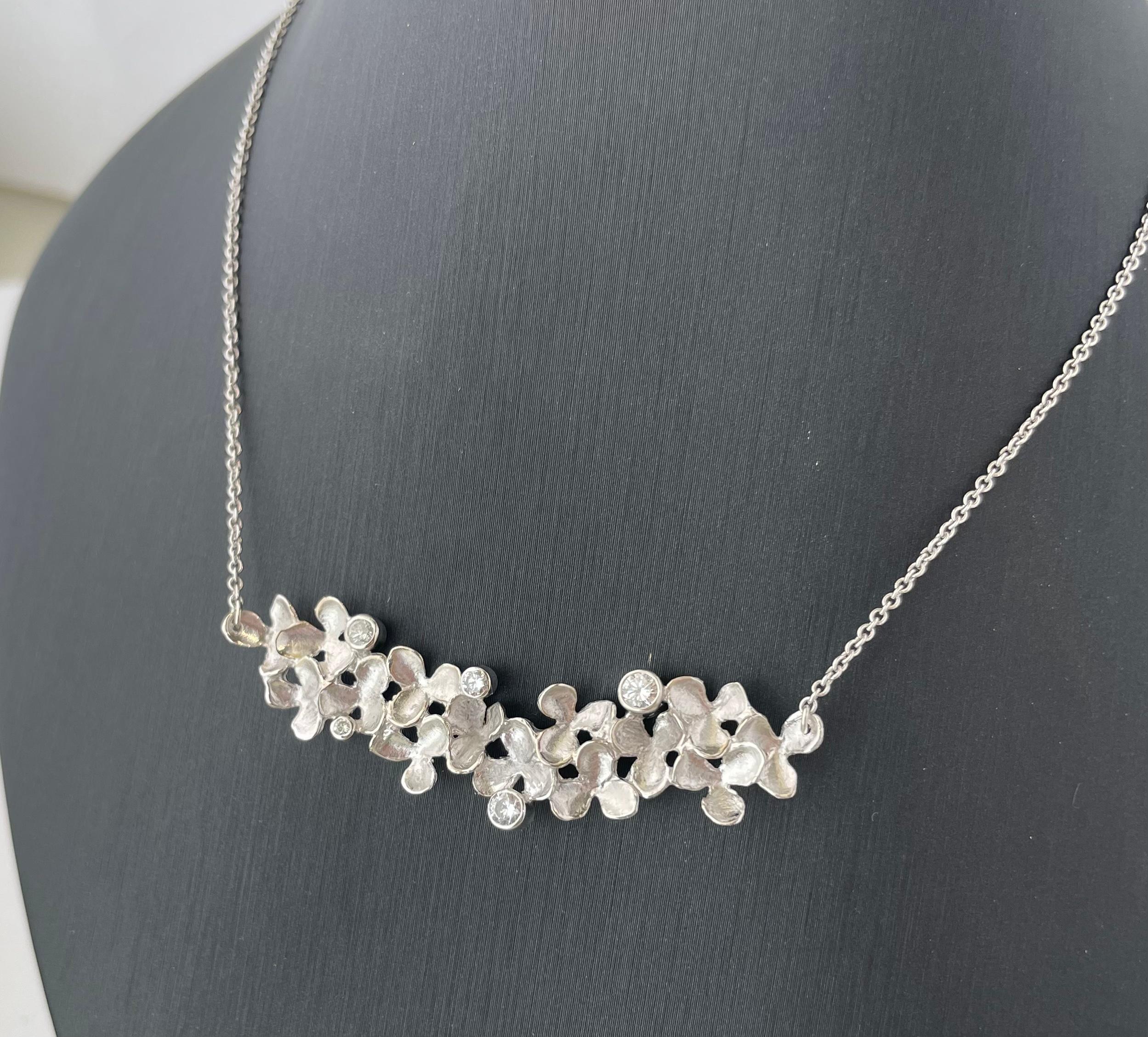 This flower bar pendant is part of InBloom Jewelry’s “Petal” collection. This collection combines inspiration from nature with technical trade skill to create a wearable work of art.

Inspired by new blooms in nature, this piece incorporates
