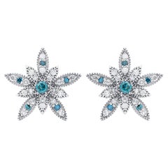 Clous d'oreilles à motif de fleurs en or blanc 14 carats avec diamants bleus et blancs