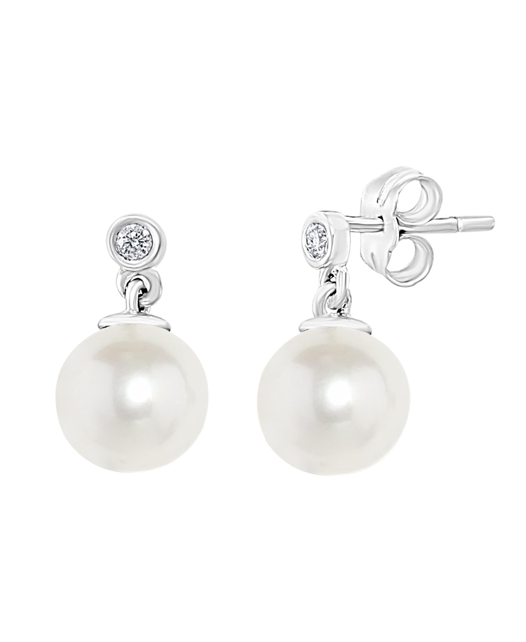 These Chinese Freshwater pearls hang off a diamond stud set in a round bezel. The classic yet versatile design of these earrings is perfect for the working woman or for an evening out on the town. 
- Total diamond weight is 0.06 carats. 
- 14K white