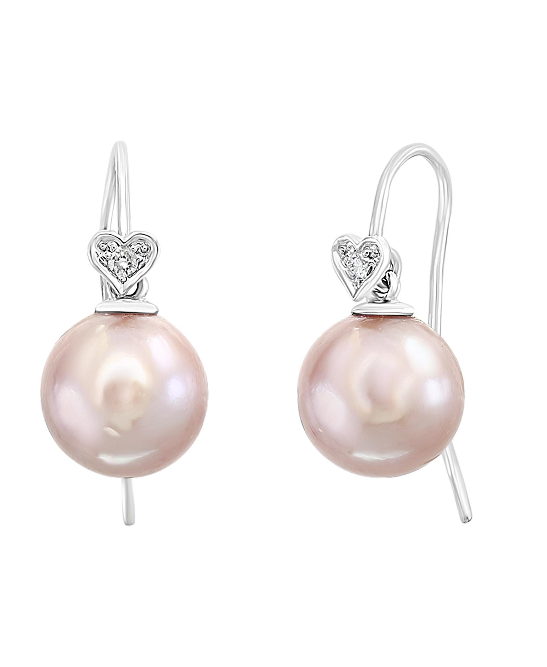These elegant Diamond and Pearl earrings contain Chinese Freshwater natural-color pink cultured round pearls measuring 10-11mm set on 14K white gold and diamond hearts with 0.06 carats of diamonds. Simple, yet elegant, these earrings are a great