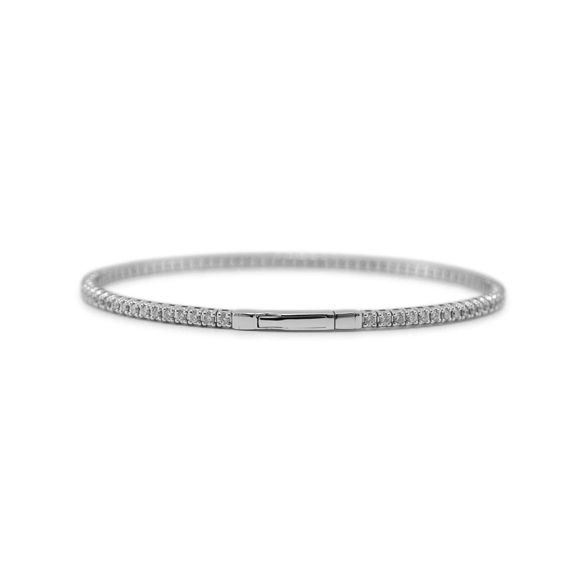 Gender: Ladies

Metal Type: 14K White Gold

Length: 6.25 inches

Width: 2.30 mm

Weight: 6.64 grams

One ladies 14K white gold diamond bangle tennis bracelet. The metal was tested and determined to be 14K white gold. Engraved with 